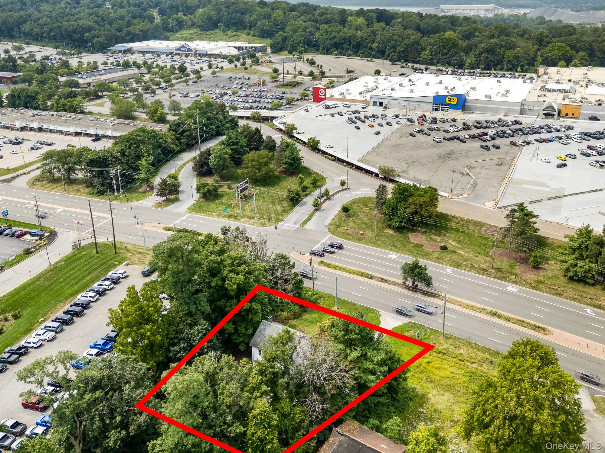 View of property location featuring property parcel outlined and a tree filled landscape