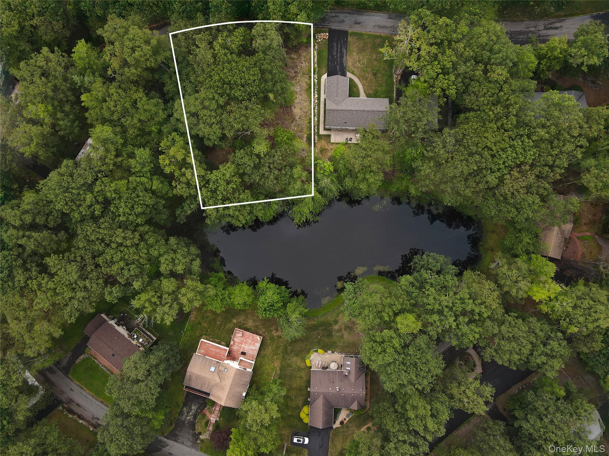 Aerial overview of property's location featuring a nearby body of water and property parcel outlined