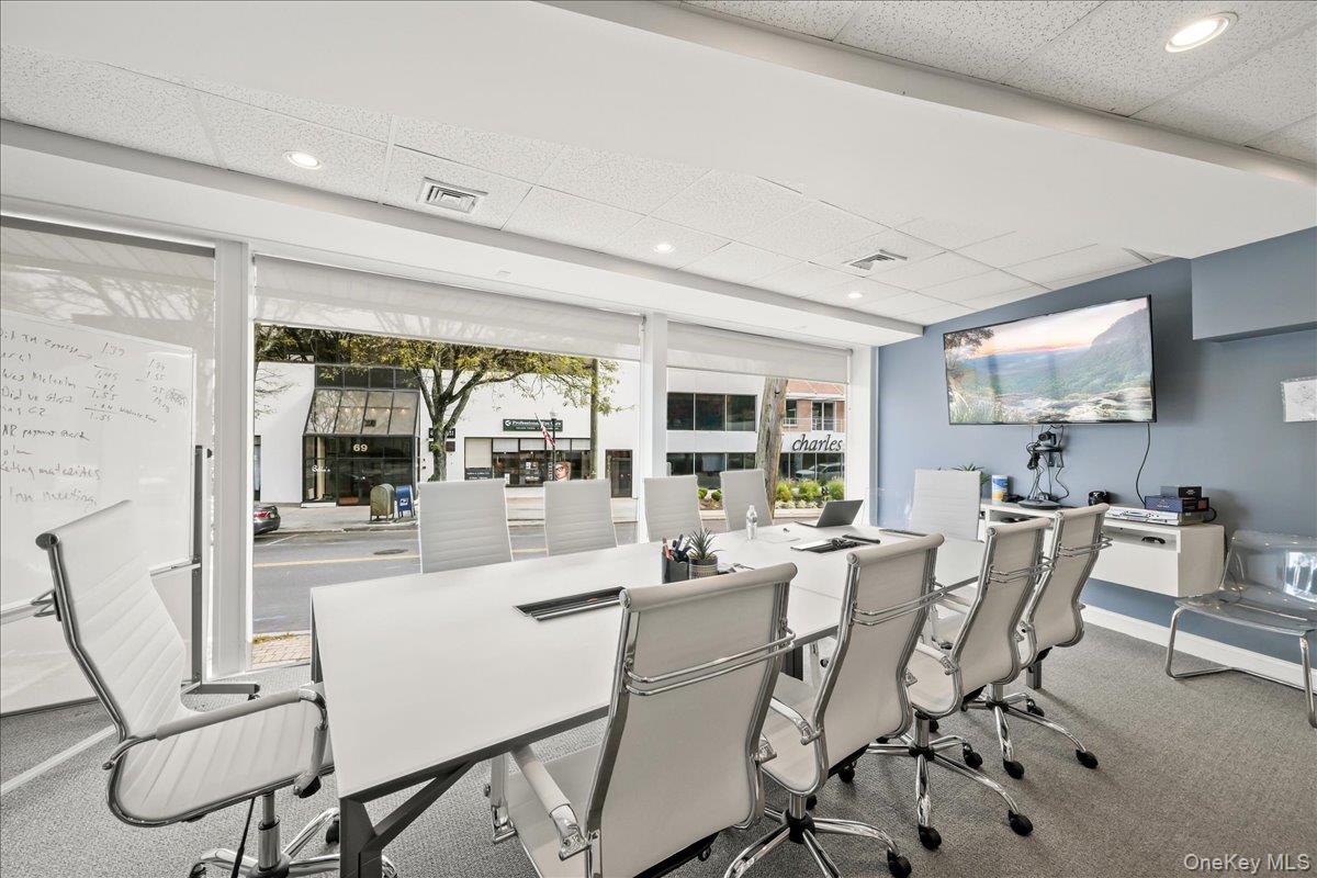 Carpeted dining room featuring a drop ceiling, an office area, and recessed lighting