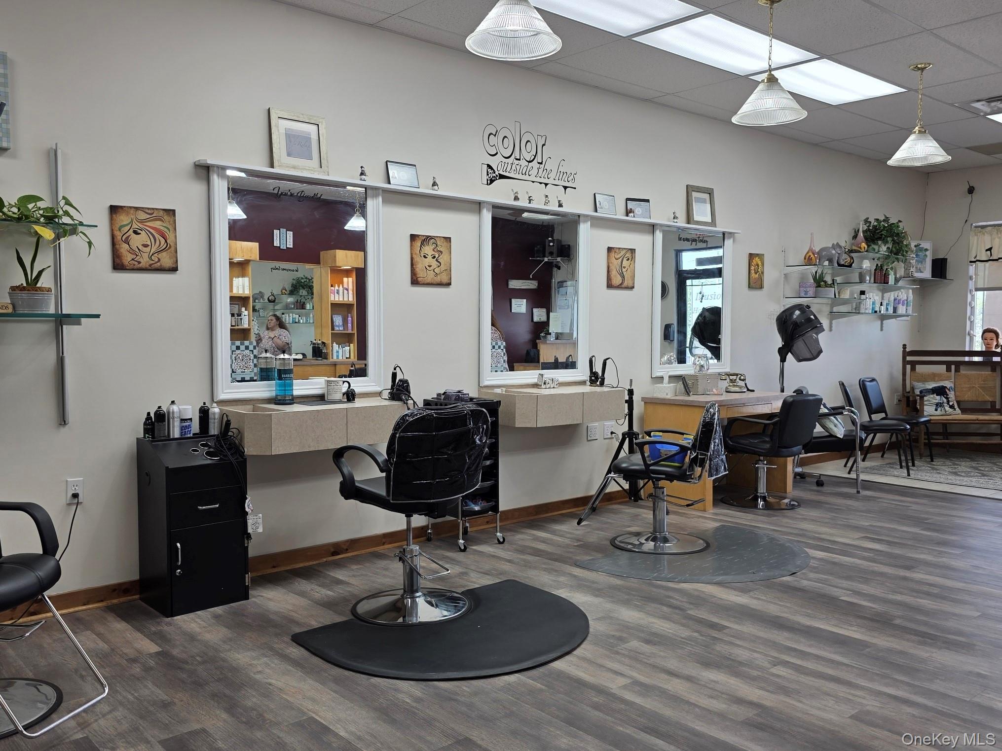 Miscellaneous room featuring a drop ceiling and dark wood-style floors