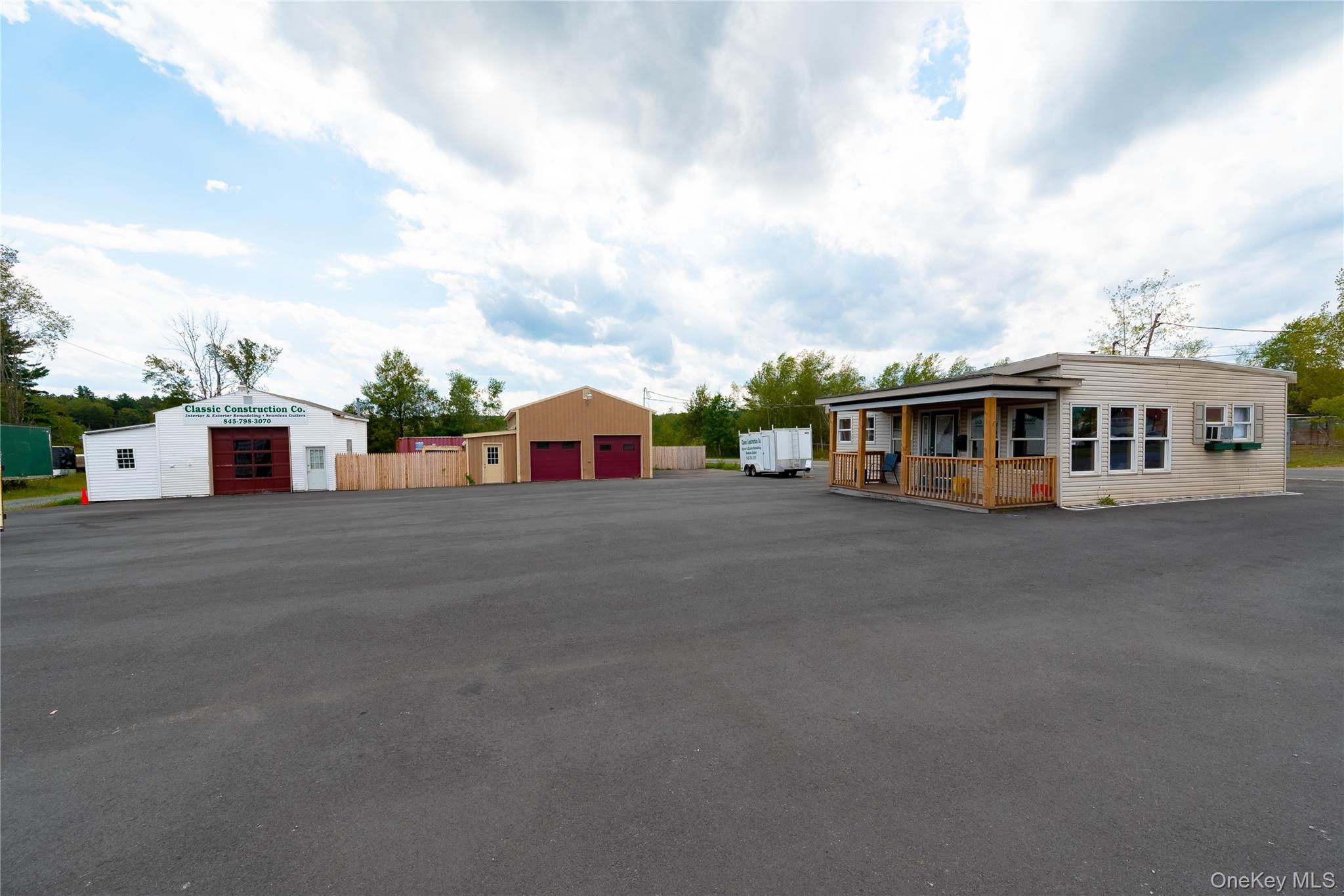 View of front of garage featuring an outdoor structure and a garage