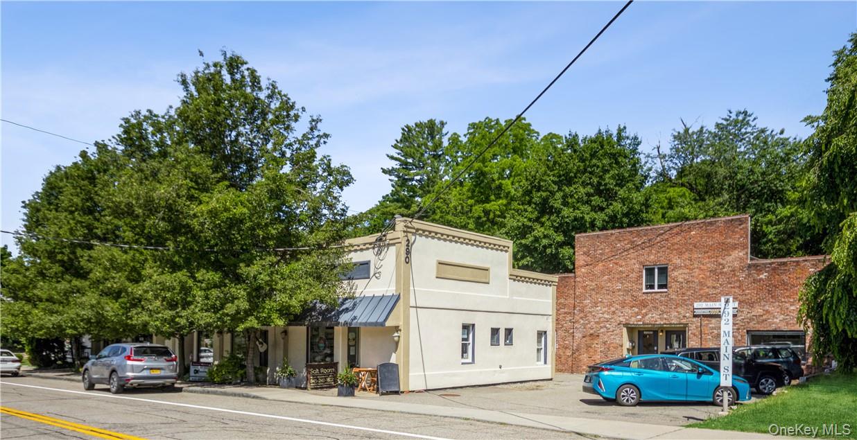 Four storefronts, plus brick office building and oversized detached garage. Off street parking