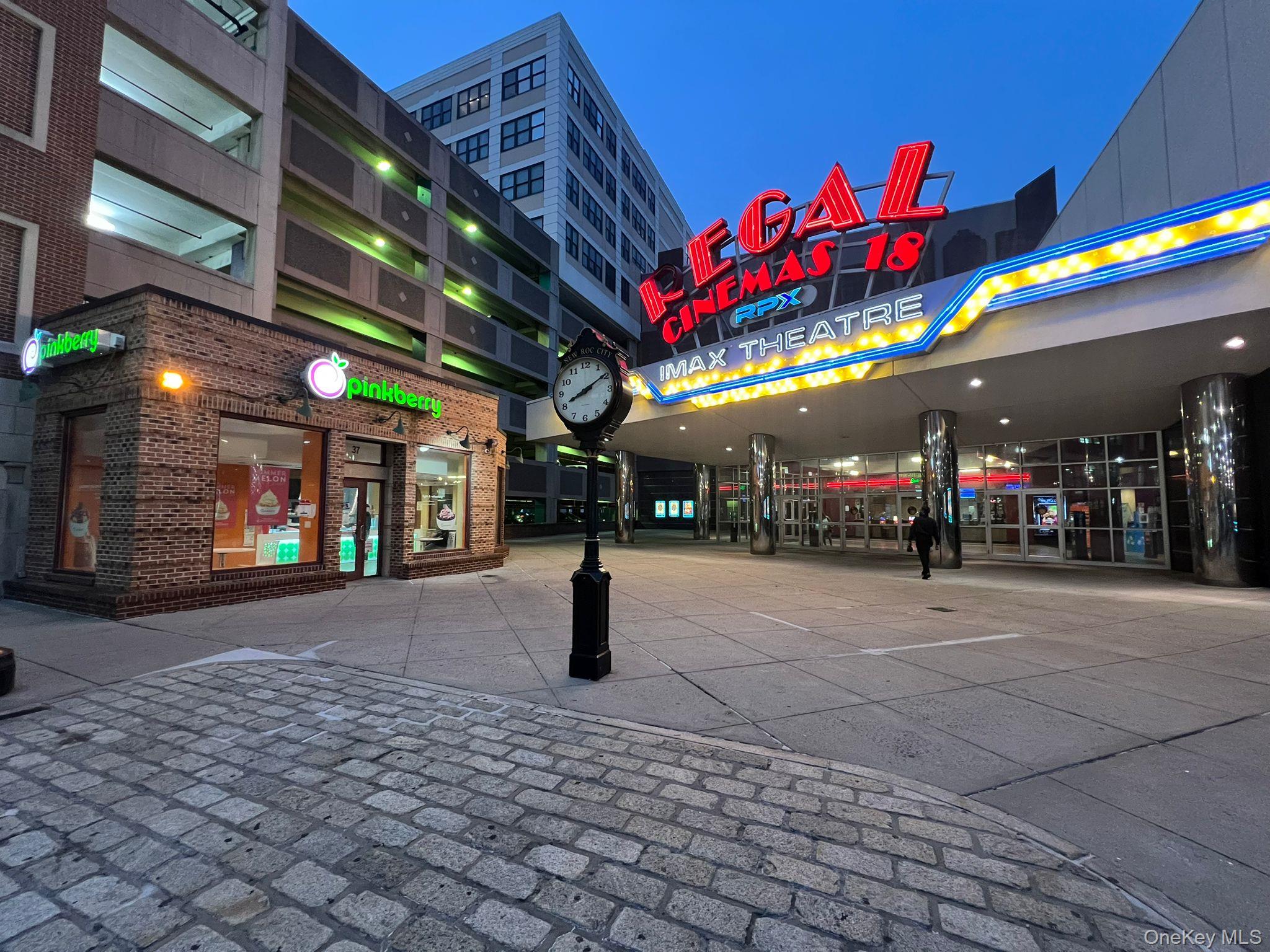 Property at twilight featuring view of commercial area