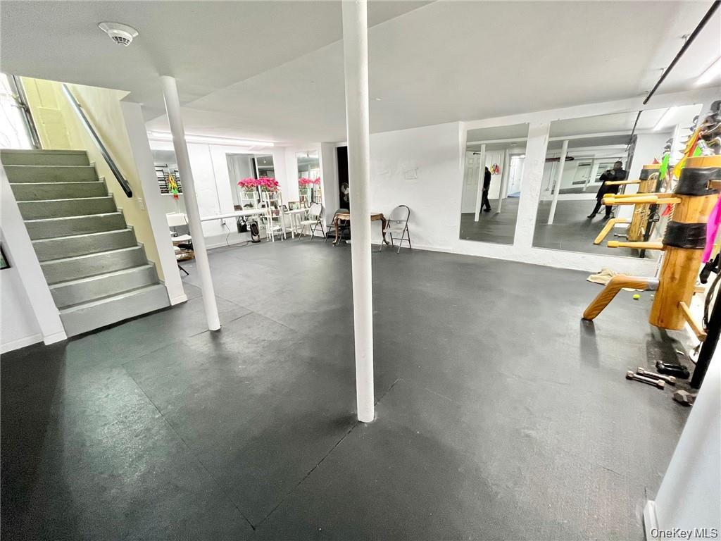 Finished below grade area with stairway and rubber floors