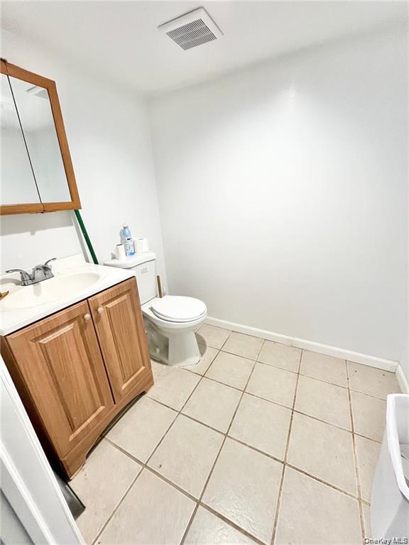 Bathroom with vanity and light tile patterned floors