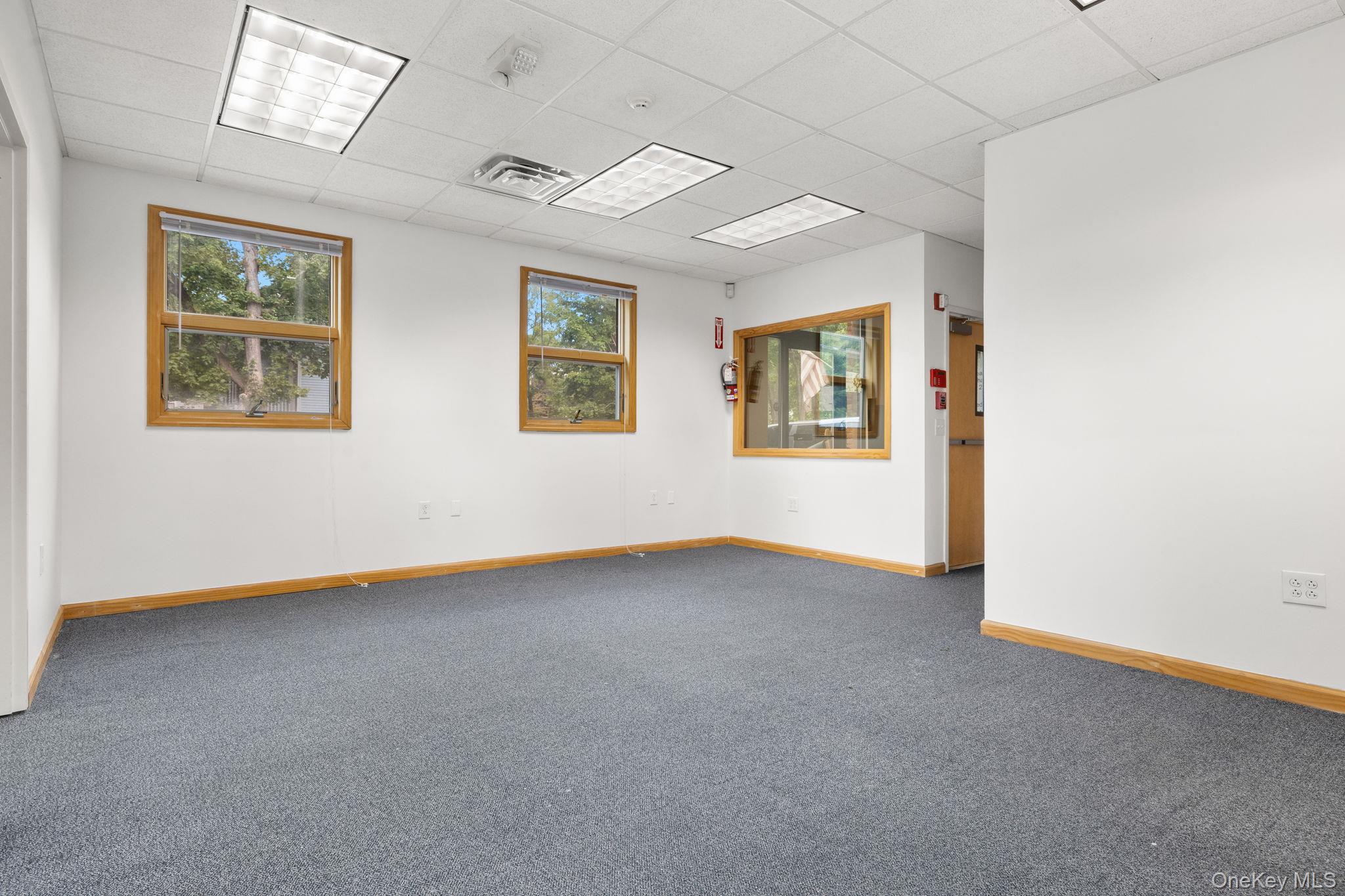 Unfurnished room with a paneled ceiling and carpet floors
