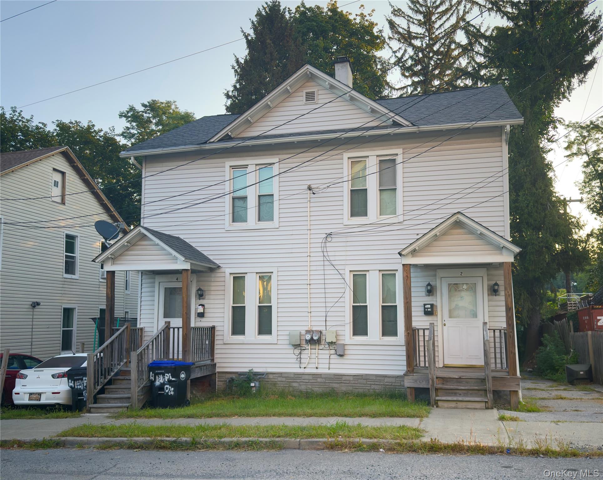 View of front of home featuring a chimney and roof with shingles