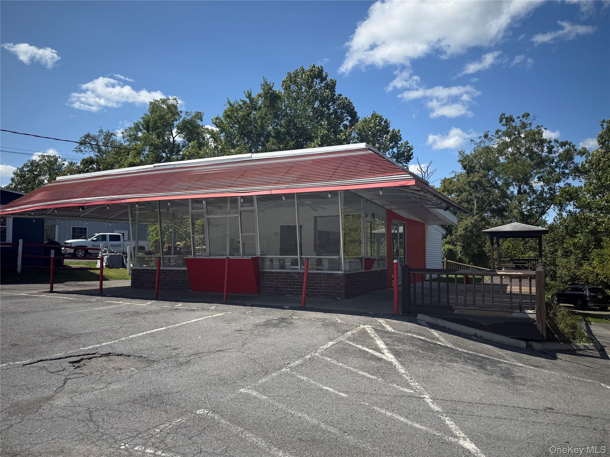 View of property featuring uncovered parking