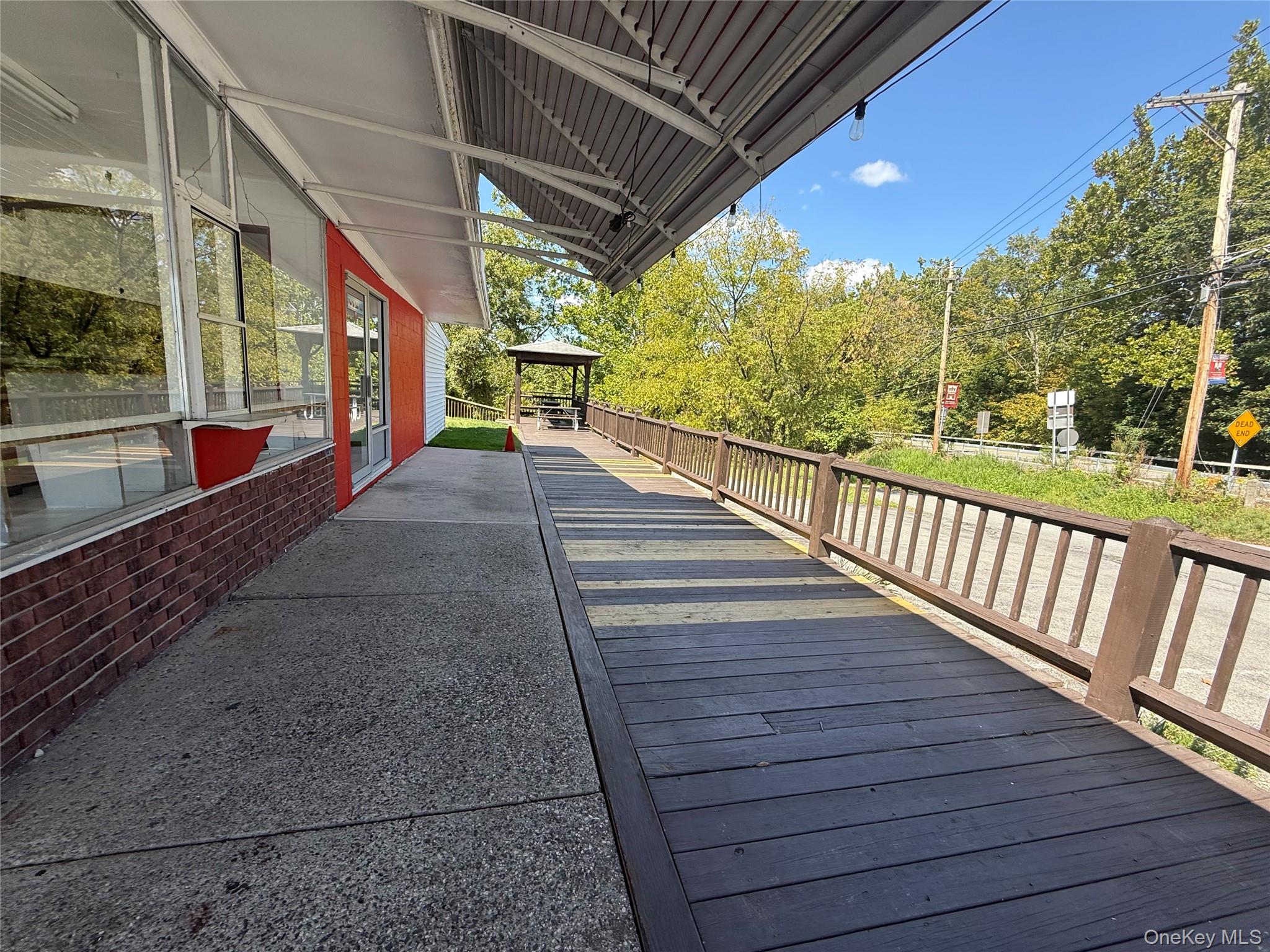 Wooden deck with a gazebo and view of scattered trees