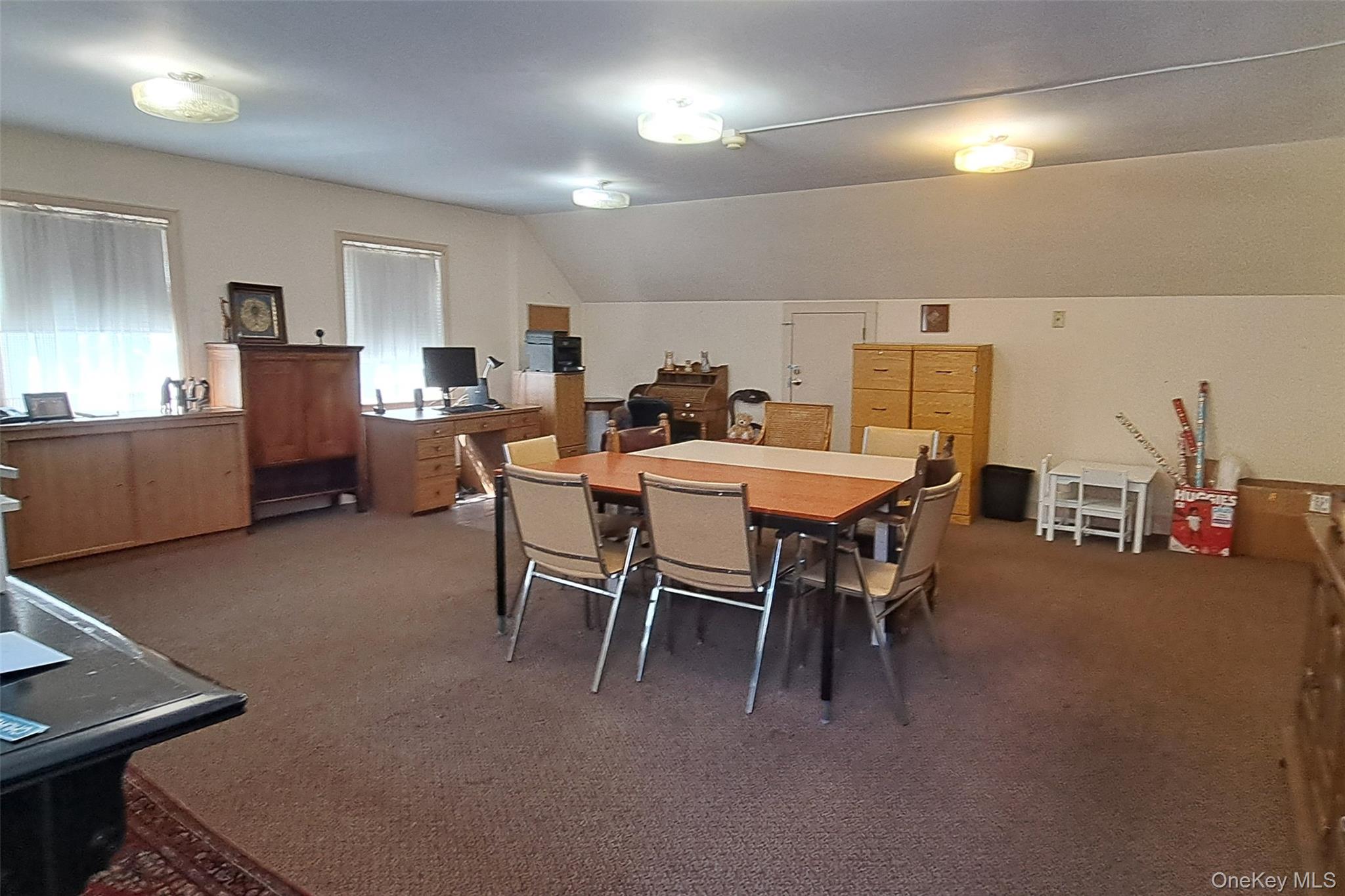 Dining area featuring carpet and lofted ceiling