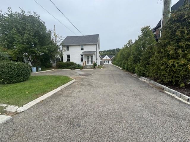 View of asphalt road featuring curbs