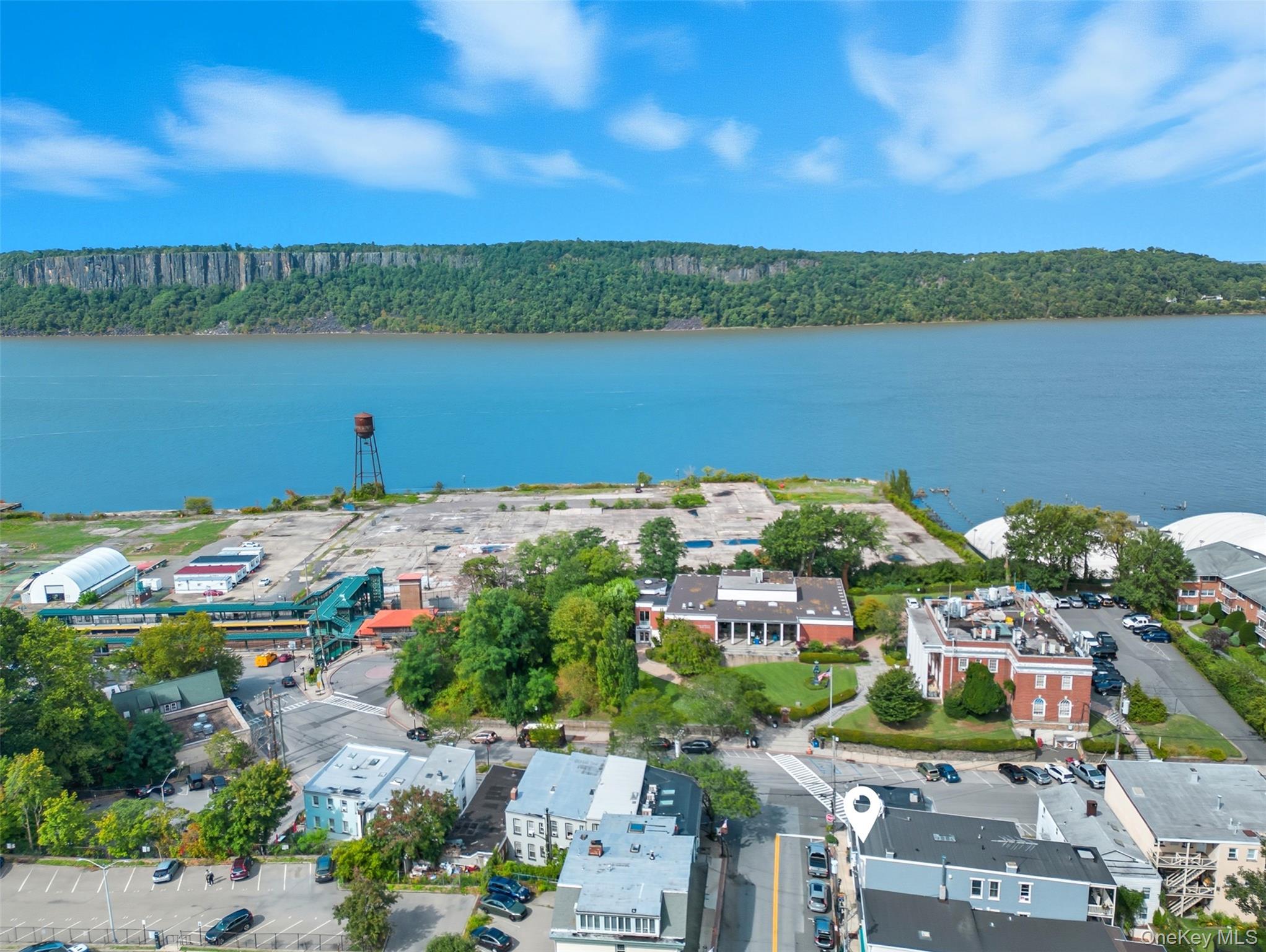 Aerial view of a heavily wooded area and a large body of water