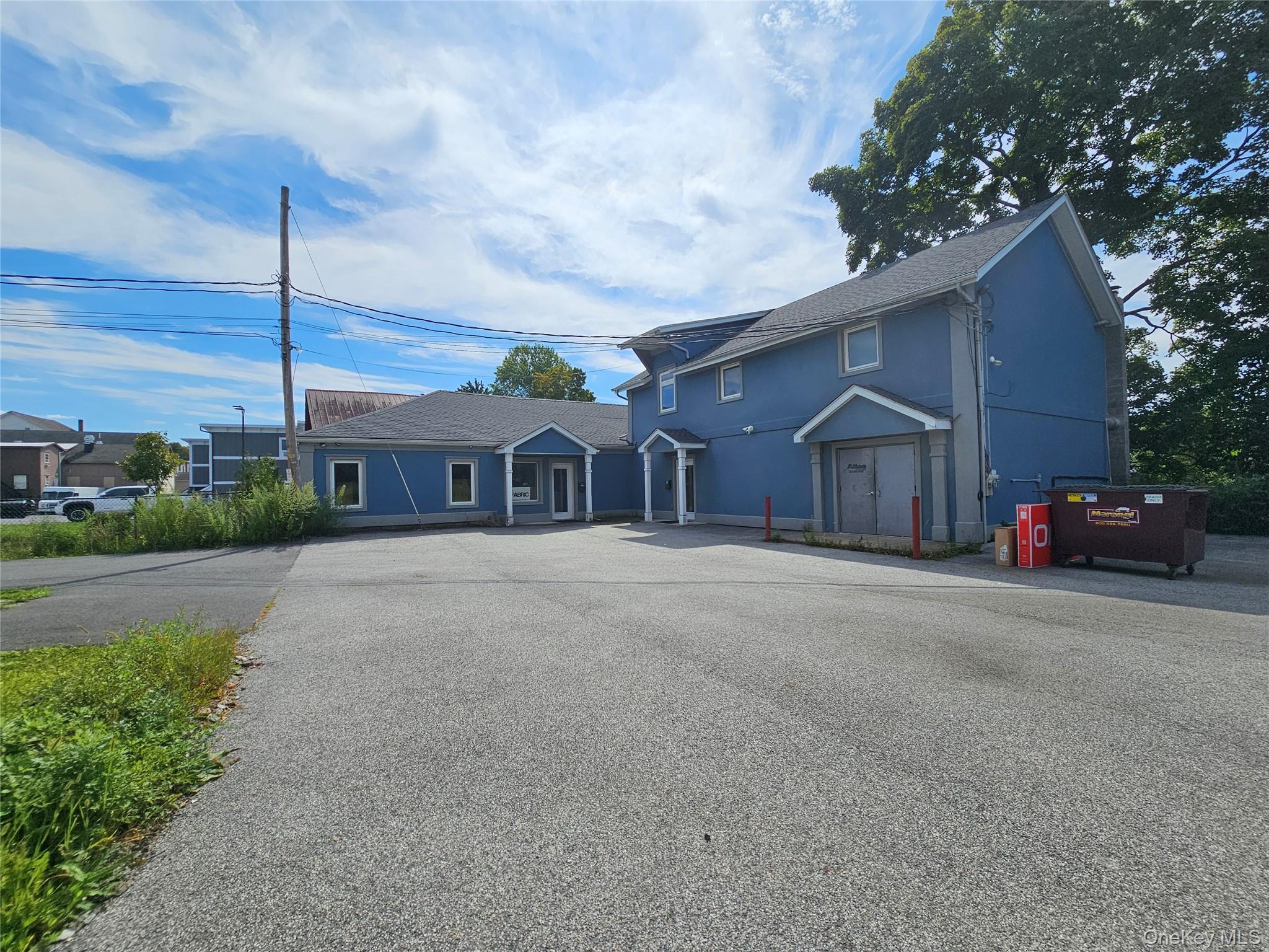 Traditional home featuring stucco siding and a shingled roof
