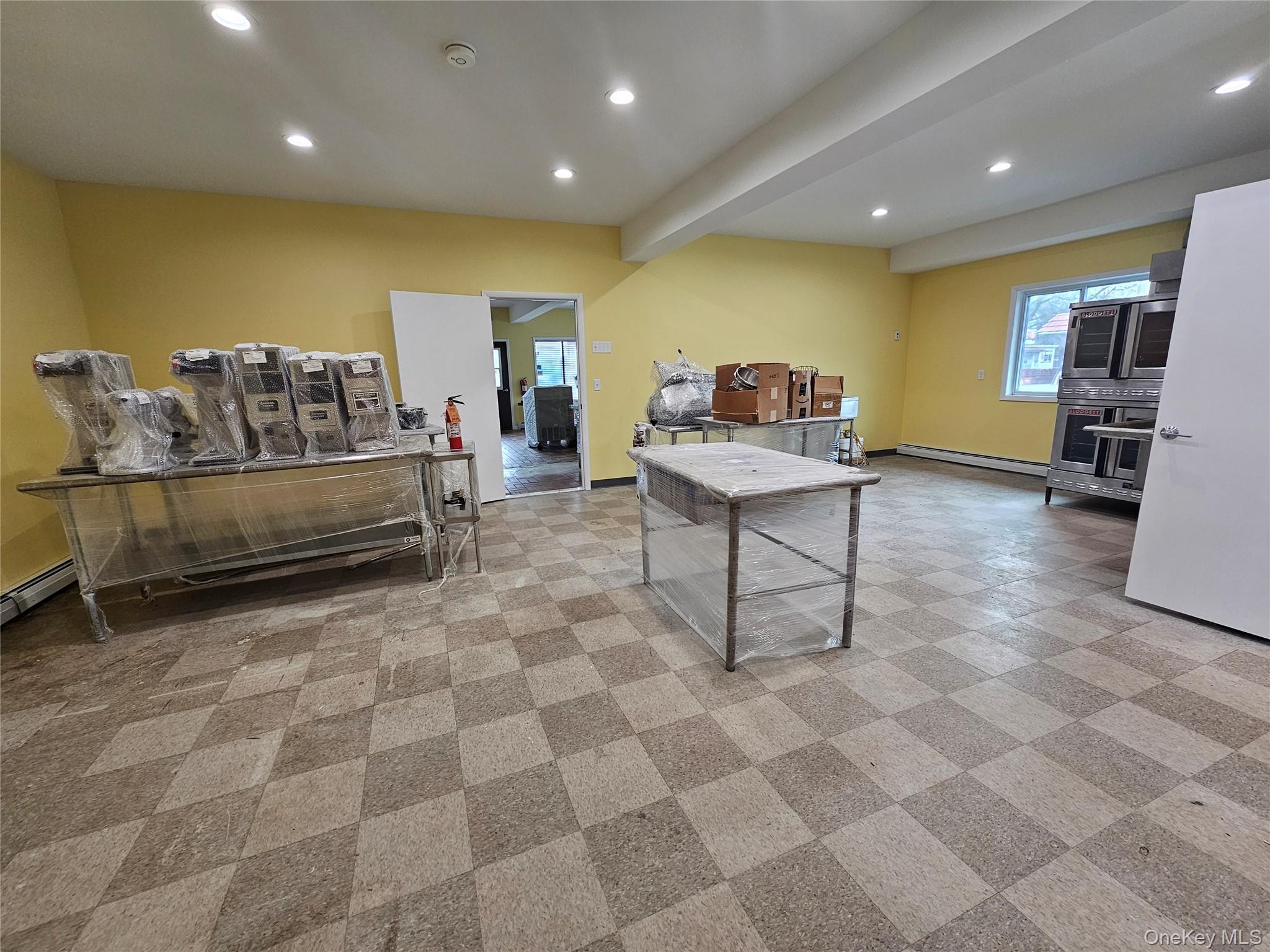 Game room with recessed lighting, baseboard heating, and beam ceiling