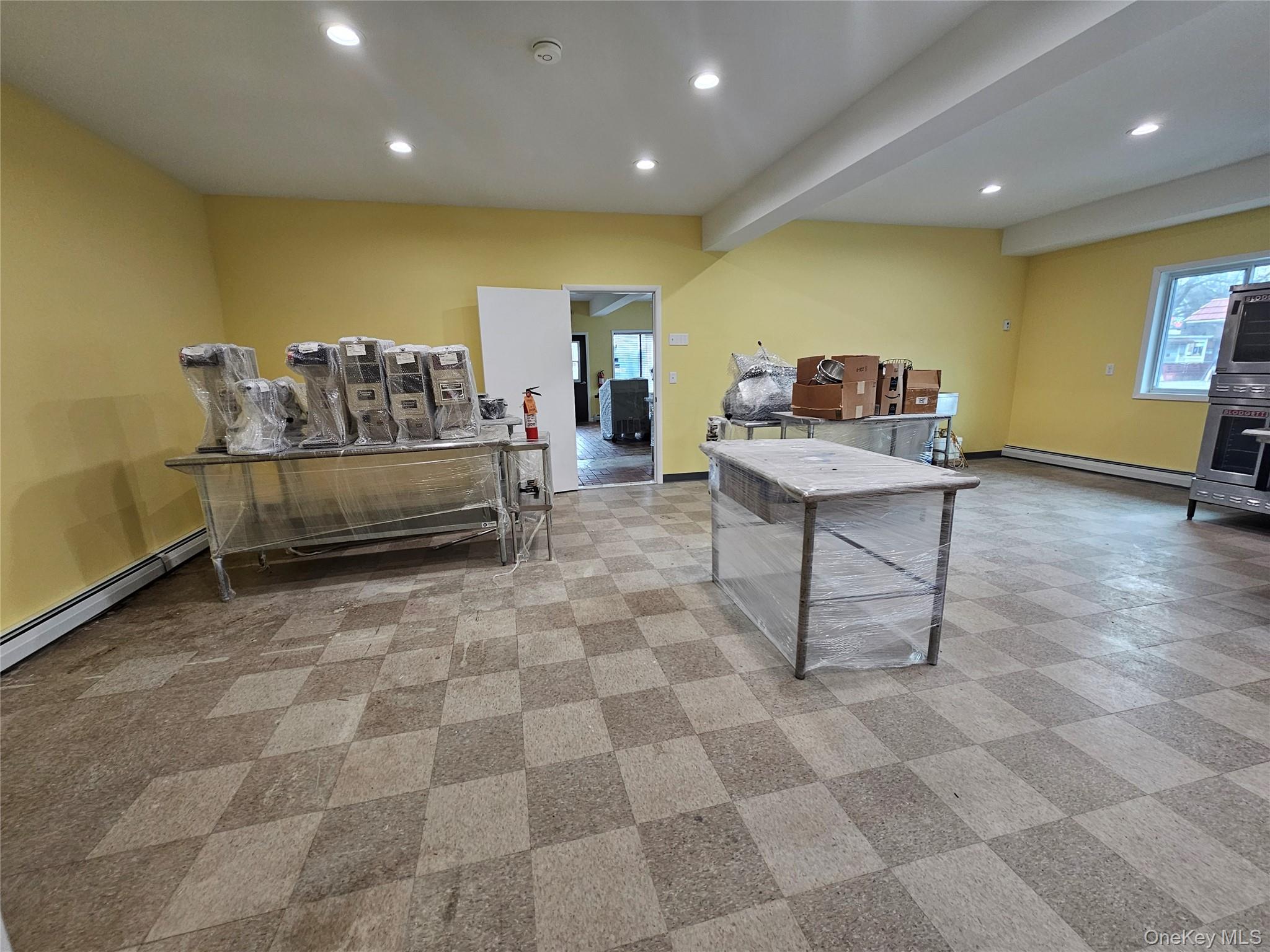 Playroom with recessed lighting, beamed ceiling, and baseboard heating