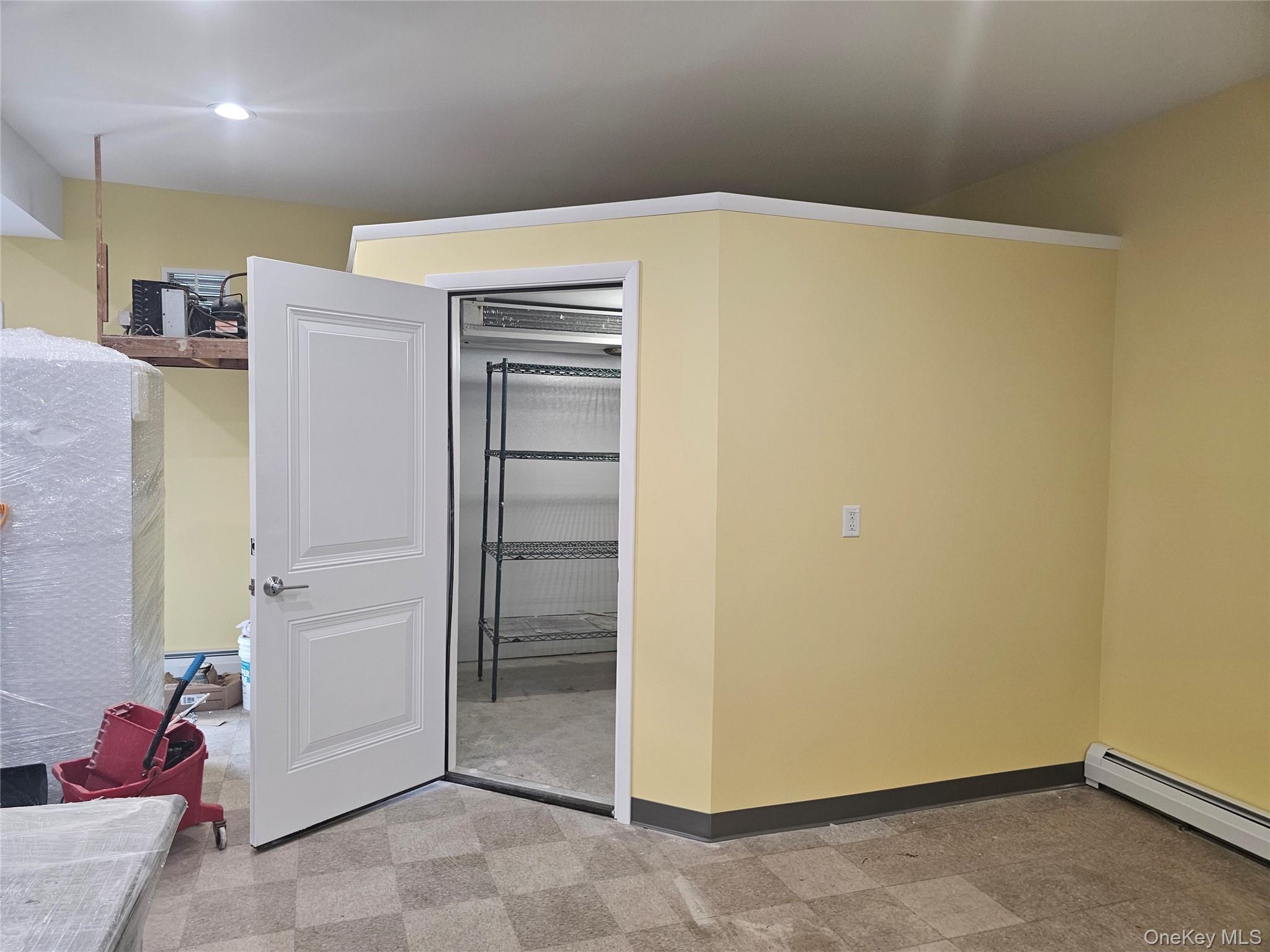 Closet with a baseboard heating unit
