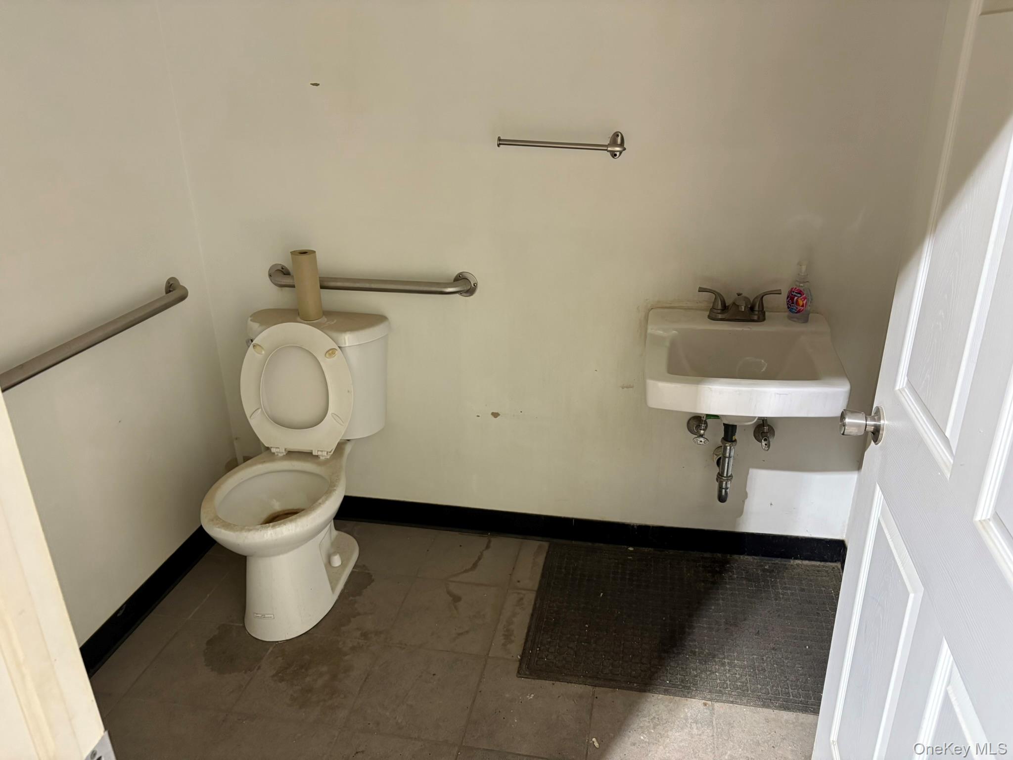 Bathroom with toilet and baseboards