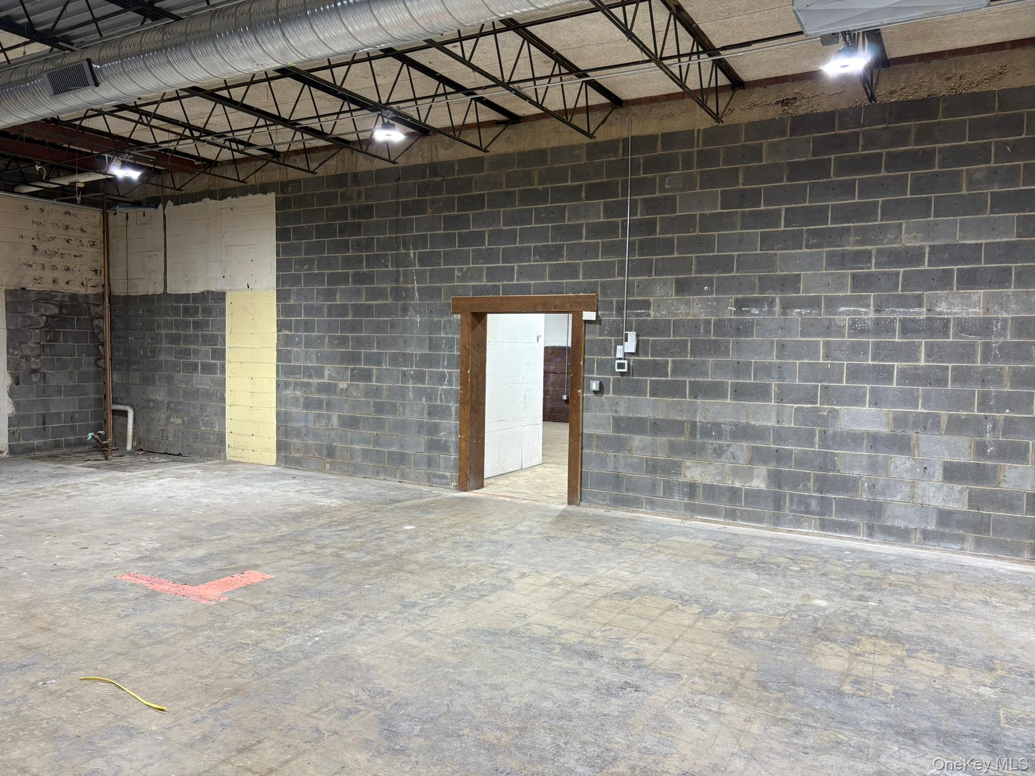 Garage featuring concrete block wall