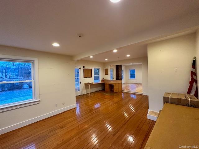 Unfurnished living room with wood-type flooring and recessed lighting