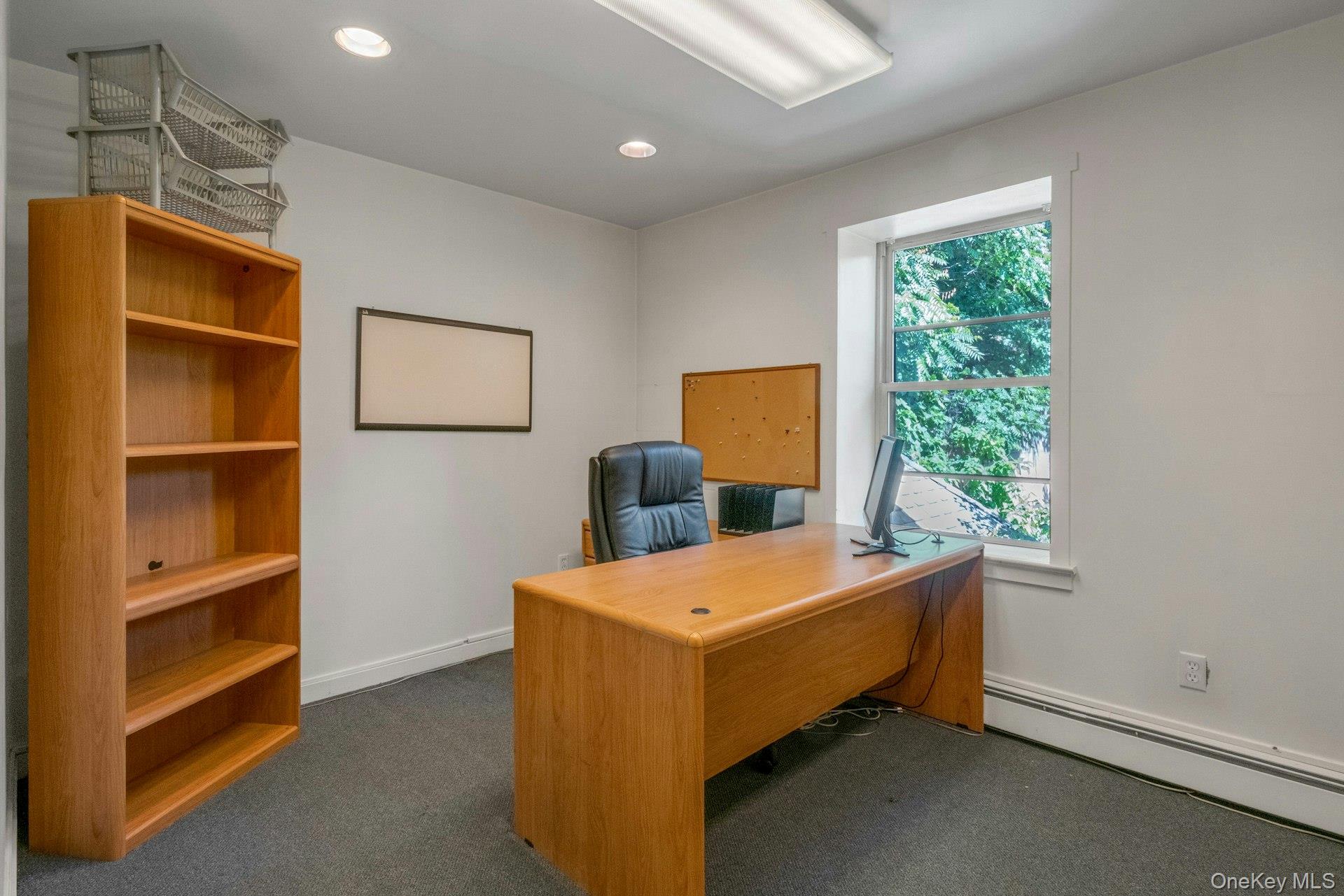 Office area featuring recessed lighting, baseboard heating, and dark carpet