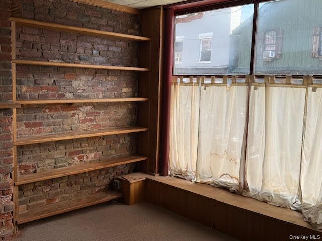 Built-in shelving by one of the front windows.