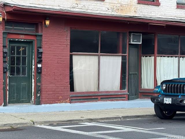 Property entrance with 2 large windows one on each side.