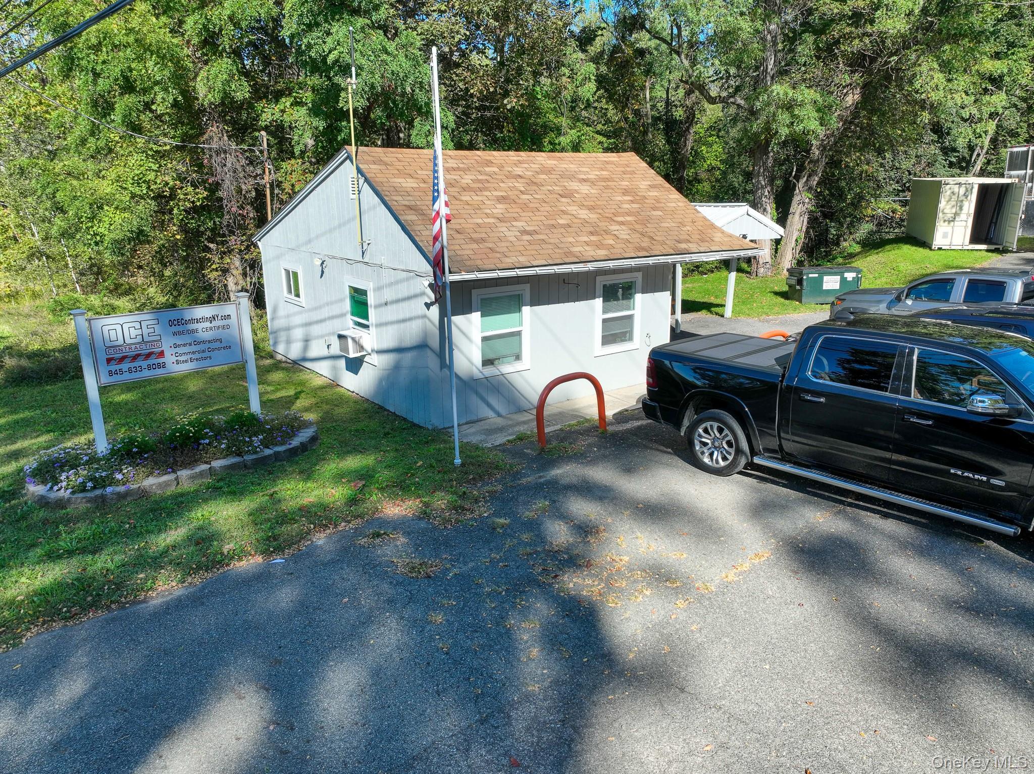 View of front of home featuring roof with shingles and a front yard
