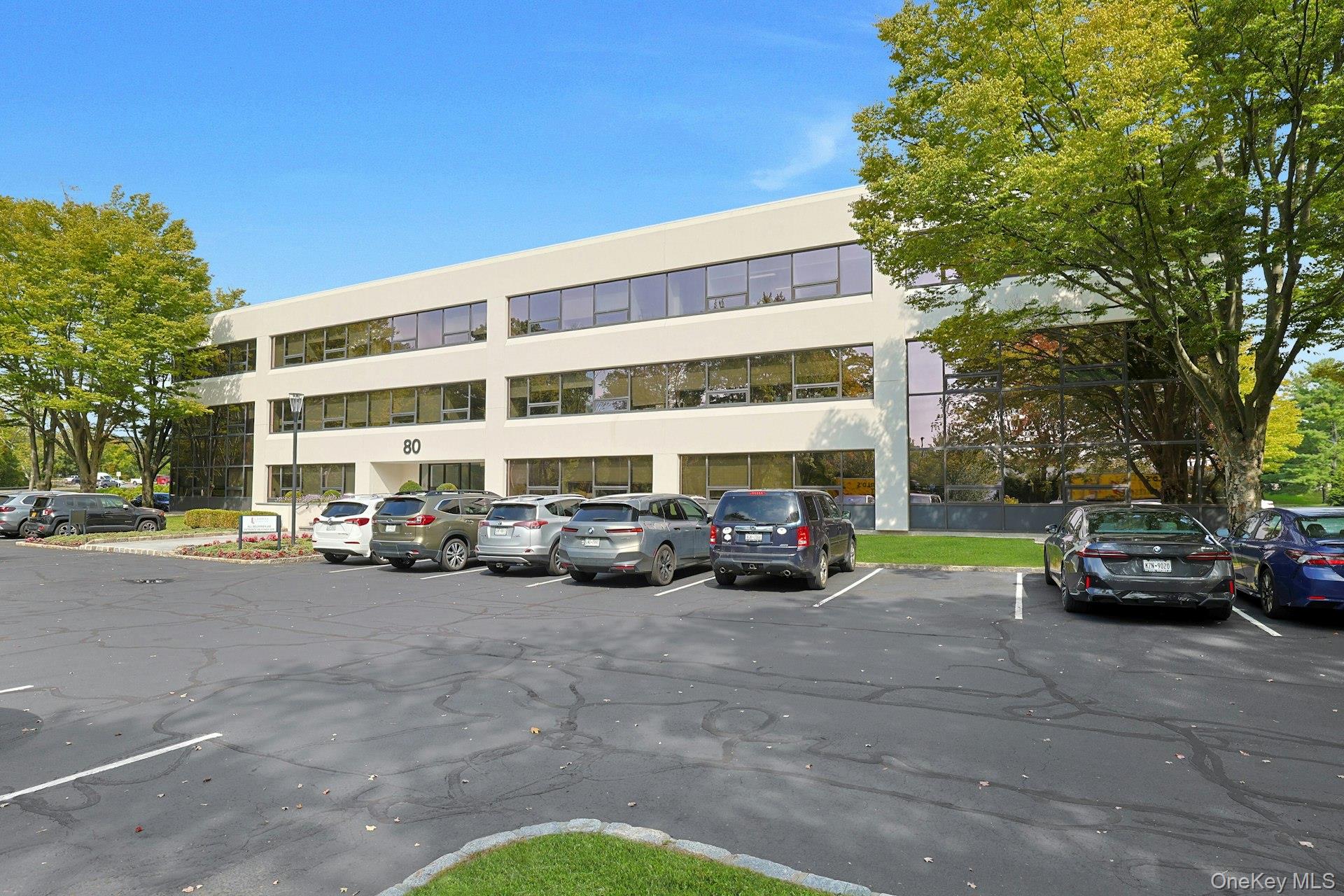 View of building exterior with uncovered parking