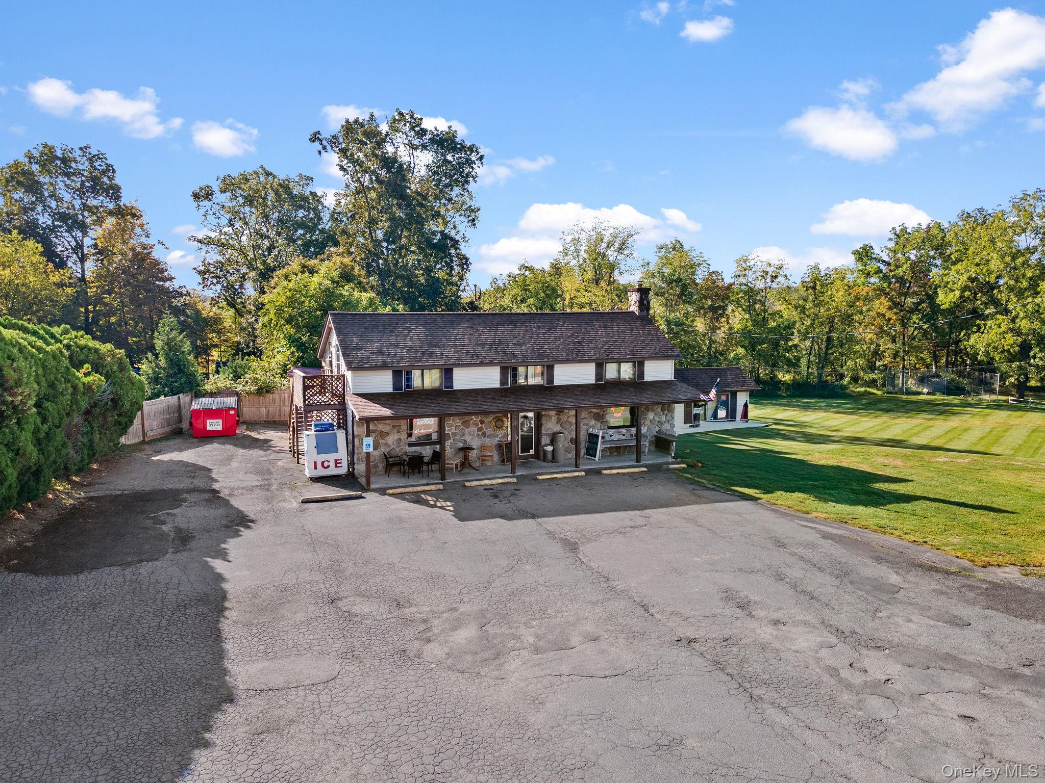Surrounding community with asphalt driveway and a porch