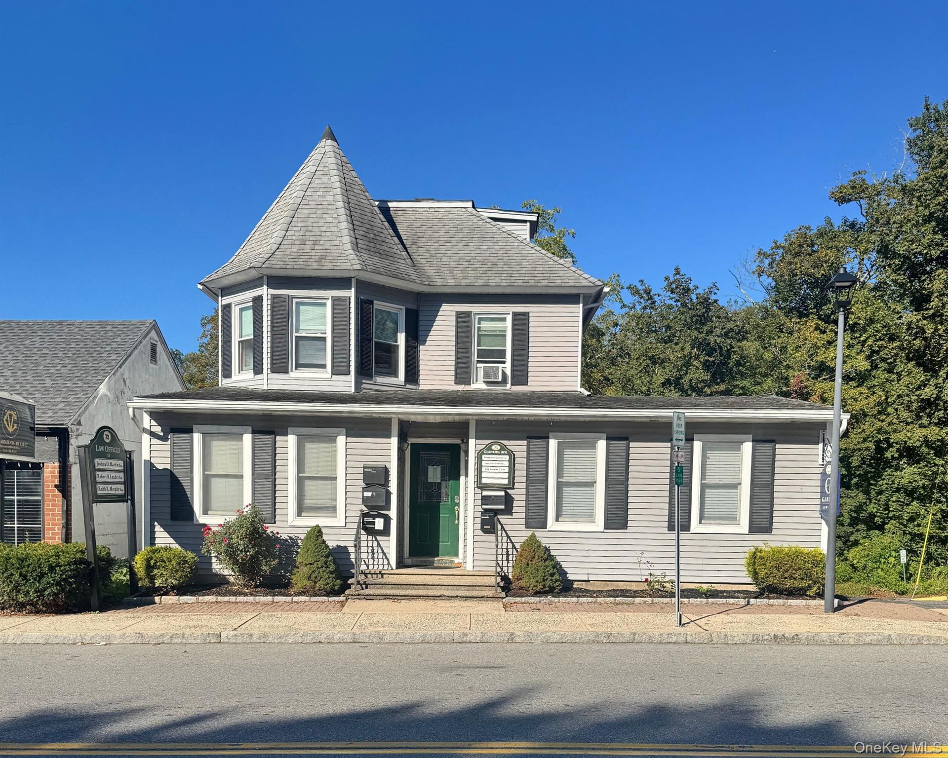 View of front of house featuring a shingled roof