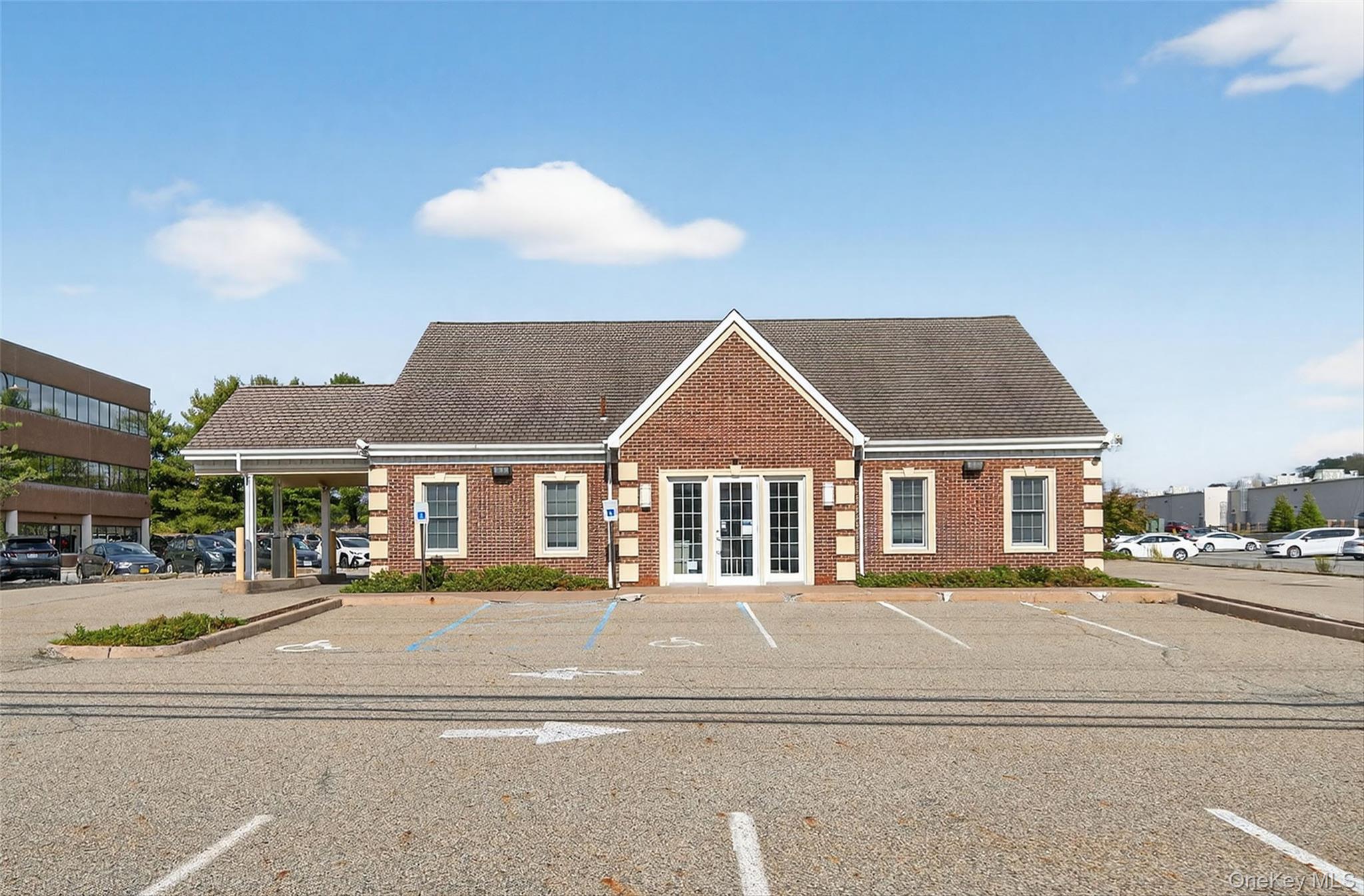 View of building exterior with uncovered parking