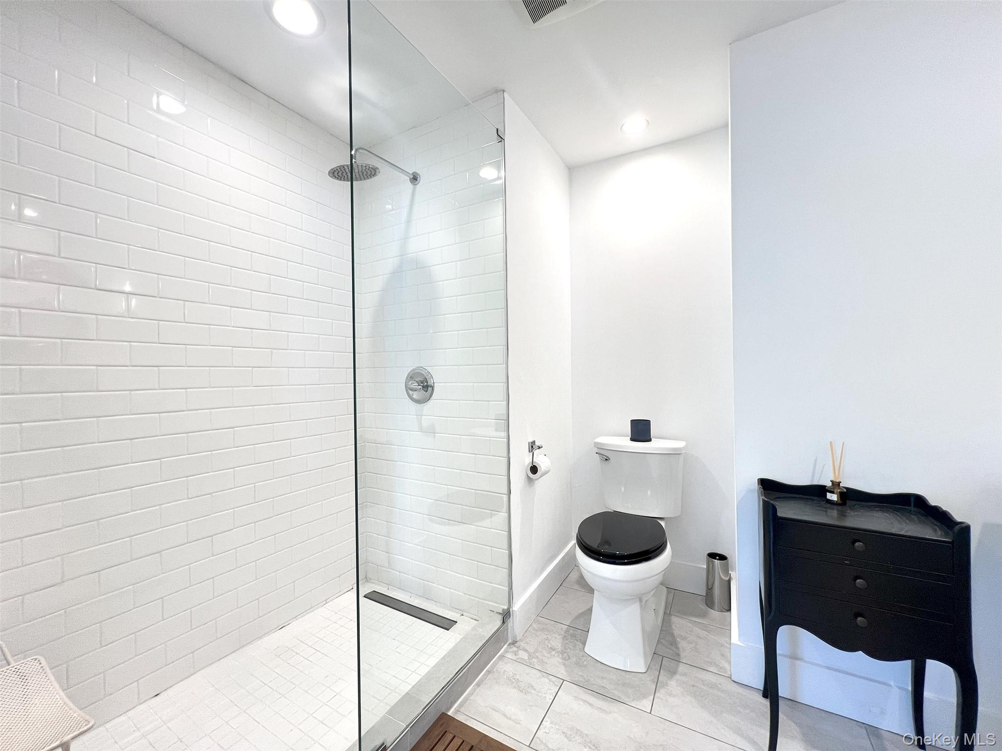 Bathroom with a tile Shower & Glass Surround