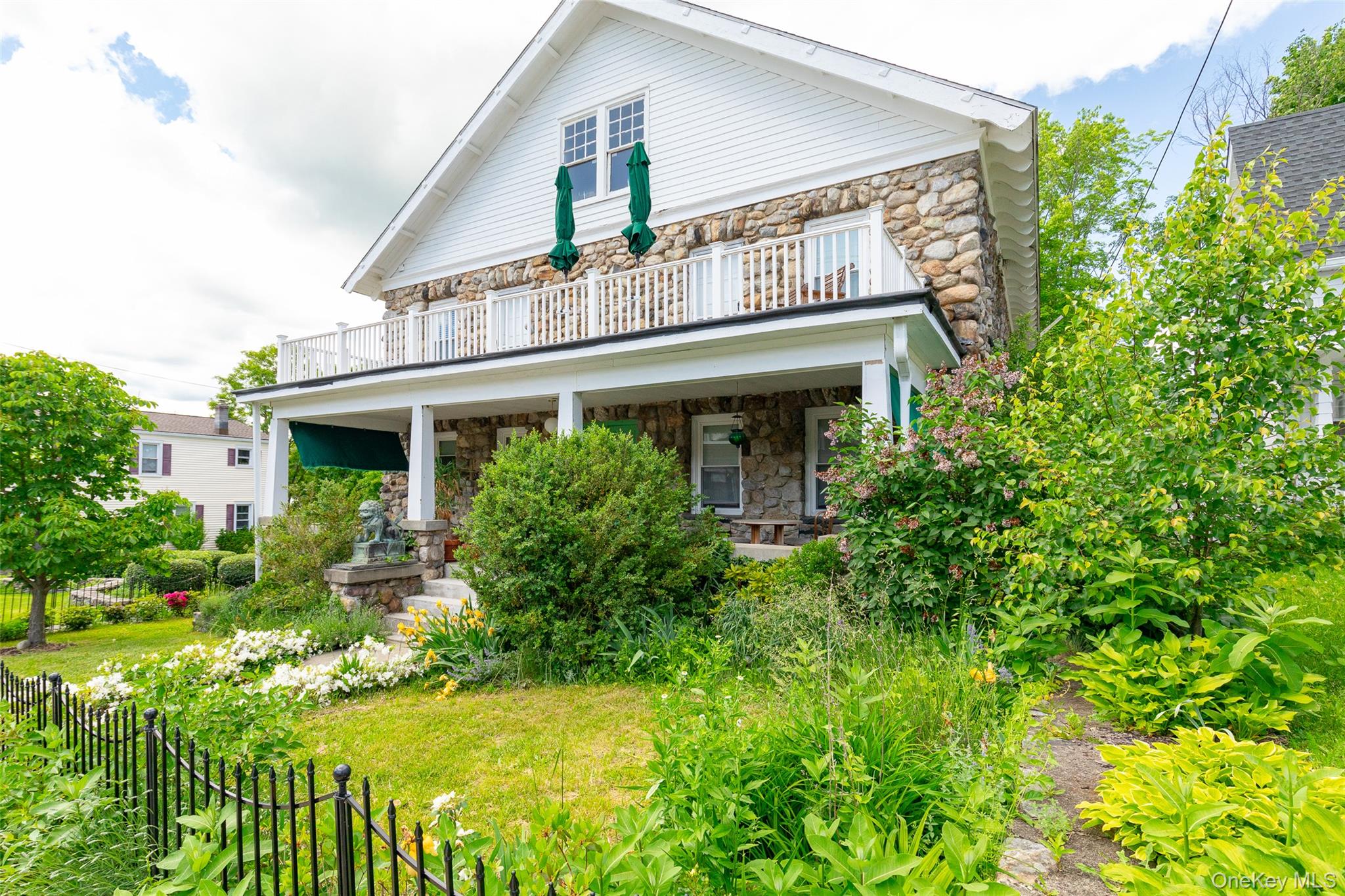 Back of house with stone siding