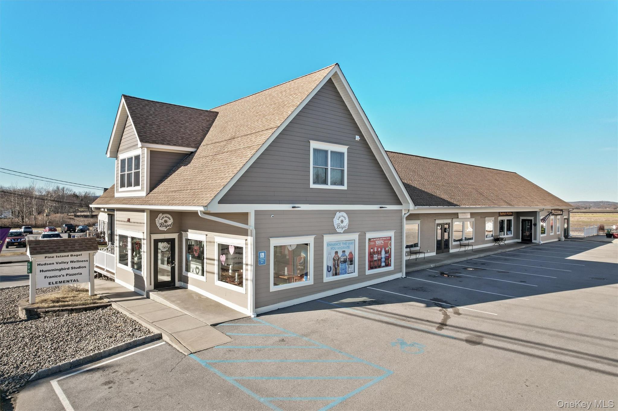 View of property featuring uncovered parking