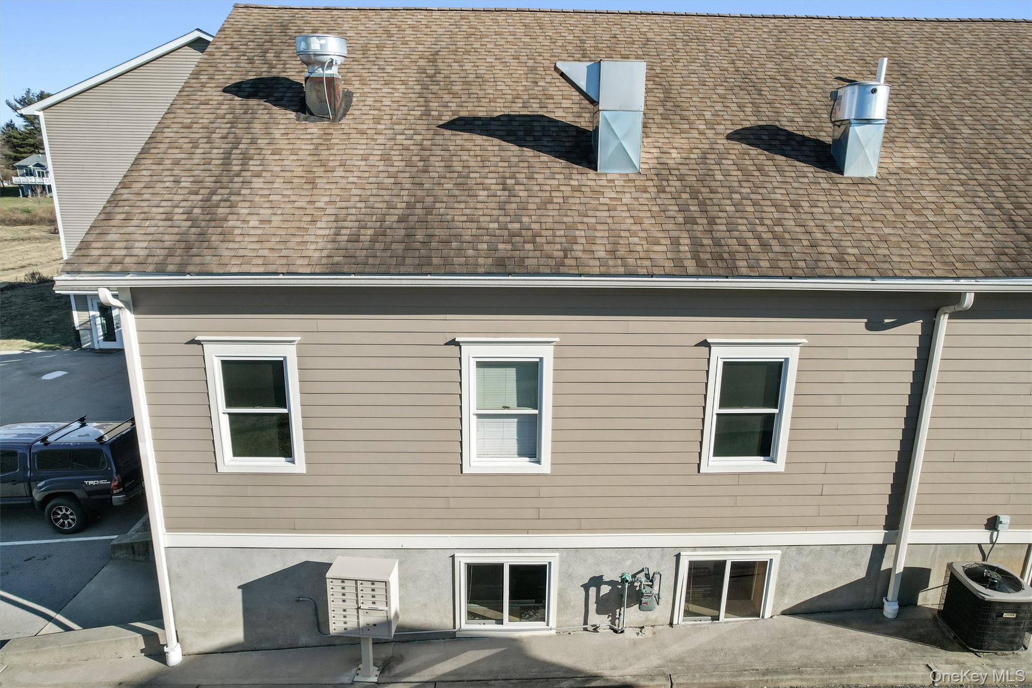 Rear view of property with a shingled roof