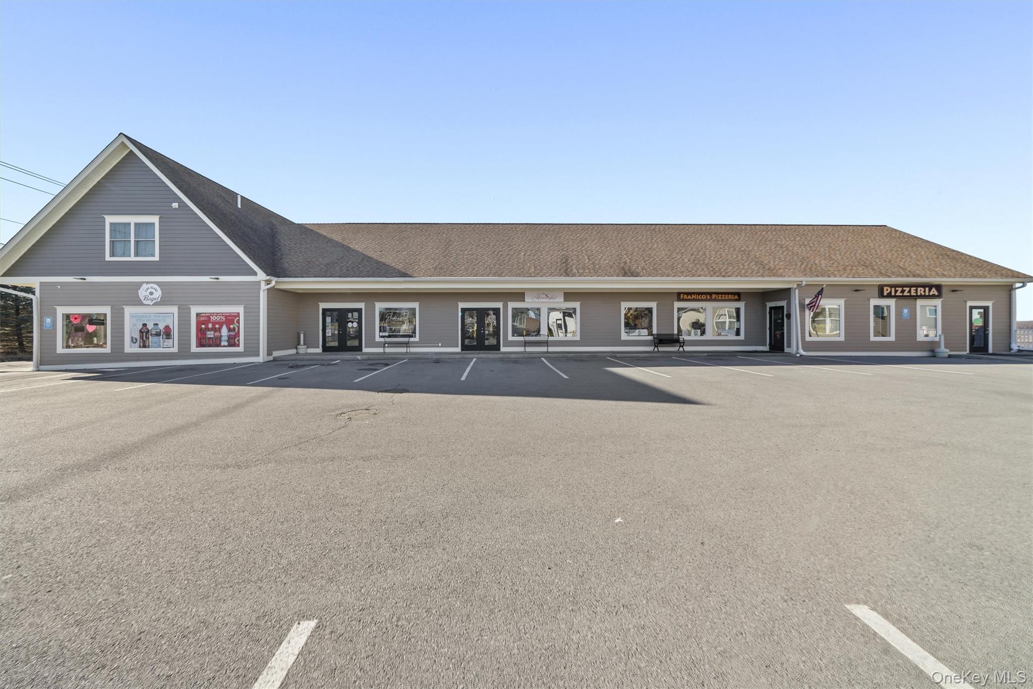 View of building exterior with uncovered parking