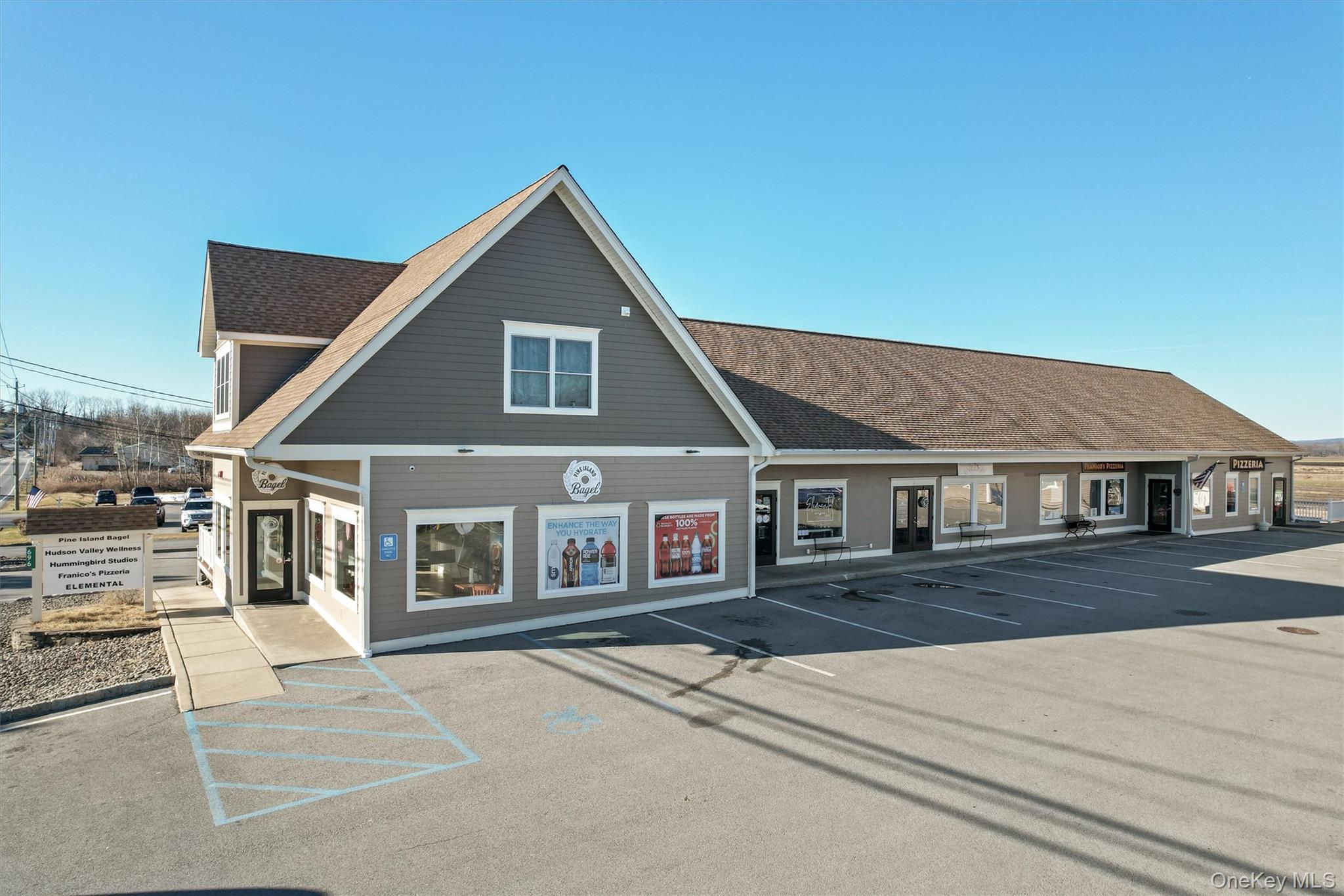 View of building exterior featuring uncovered parking