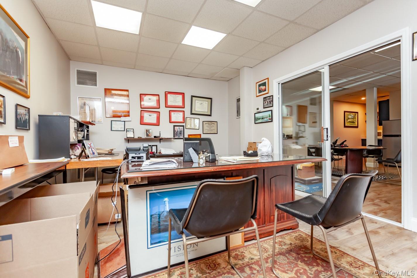 Office featuring a drop ceiling and light wood-type flooring