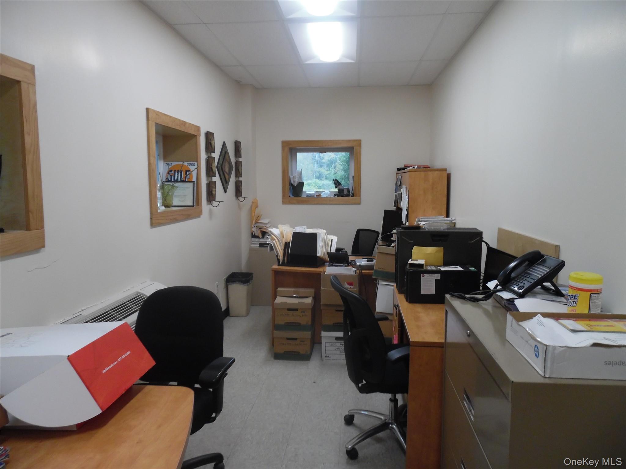 Office with a paneled ceiling