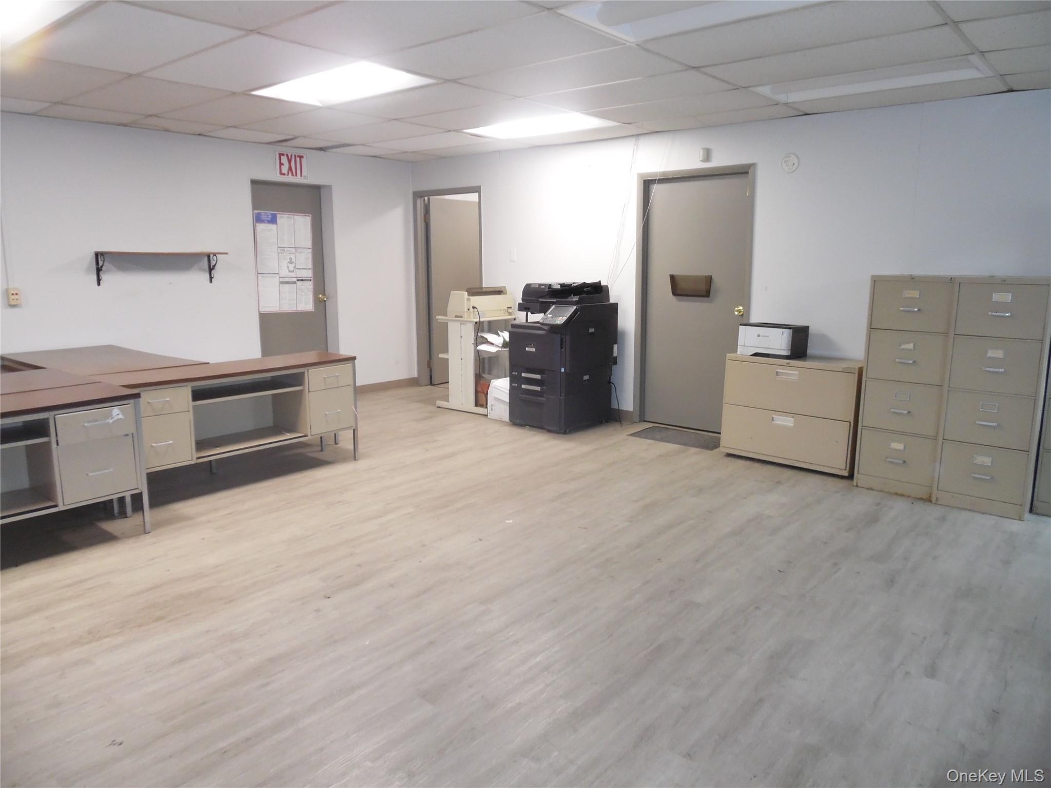 Office space featuring a paneled ceiling and light wood finished floors