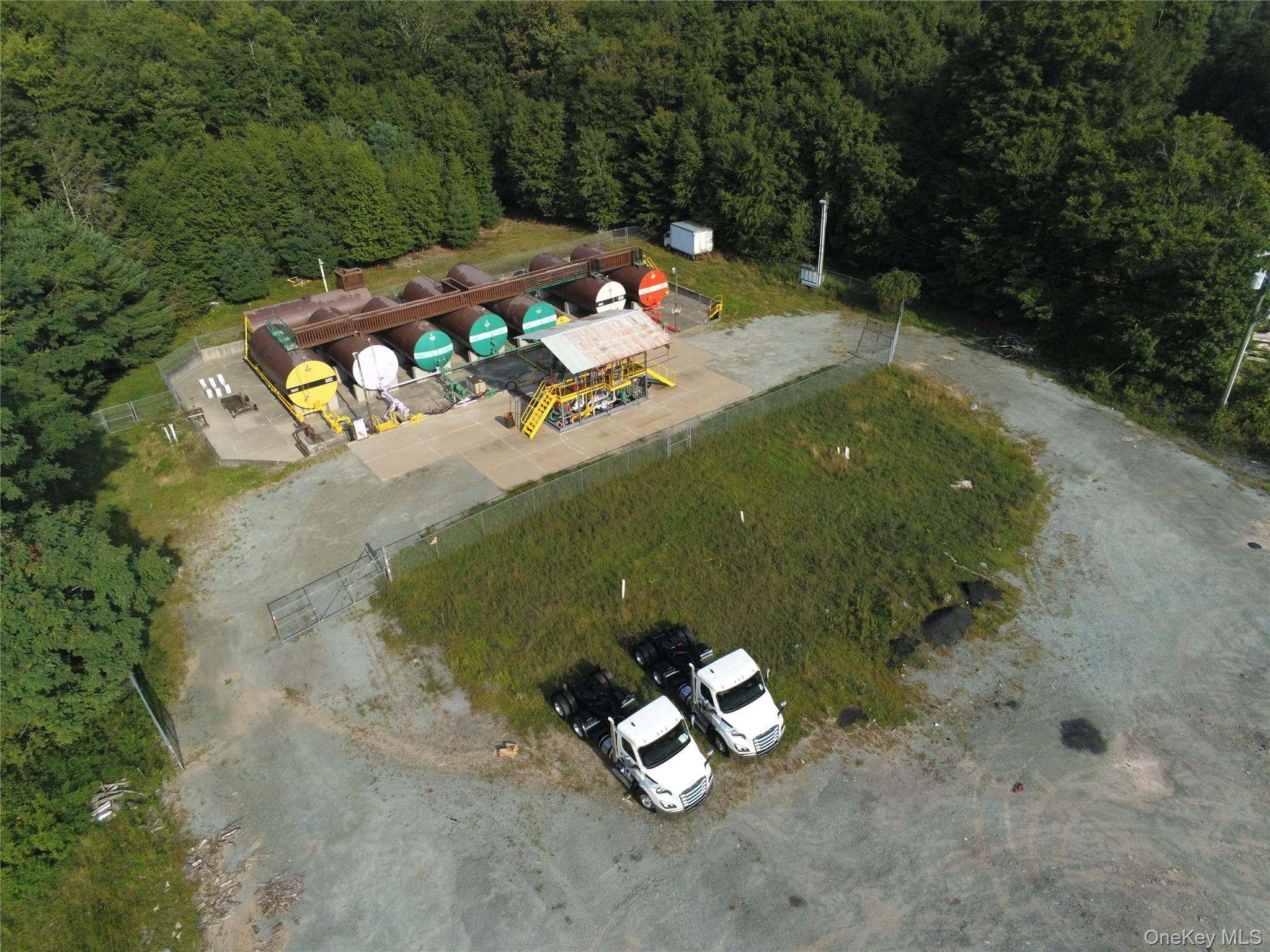 Aerial overview of property's location with a heavily wooded area