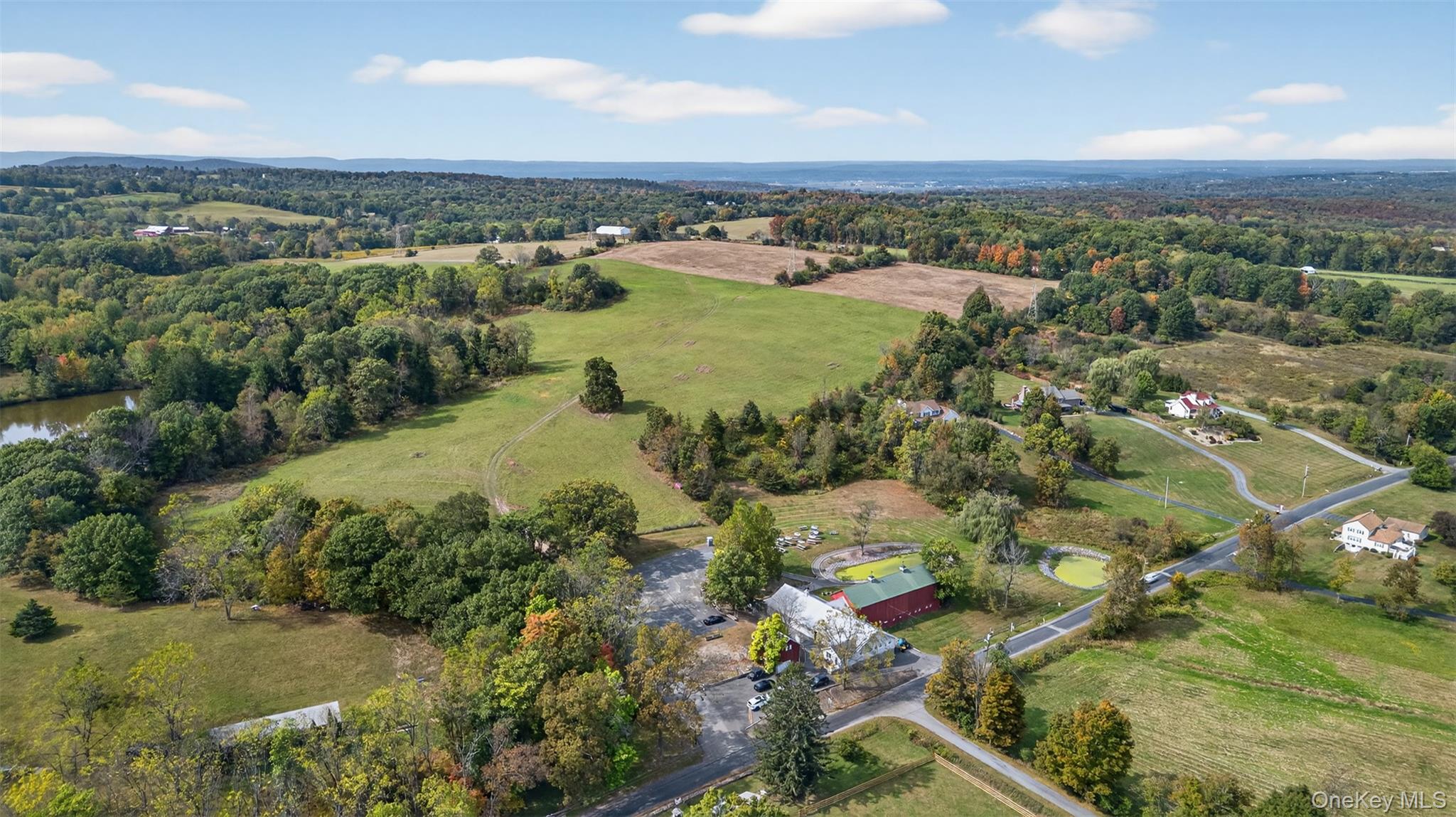 View of property location with rural landscape and a large body of water