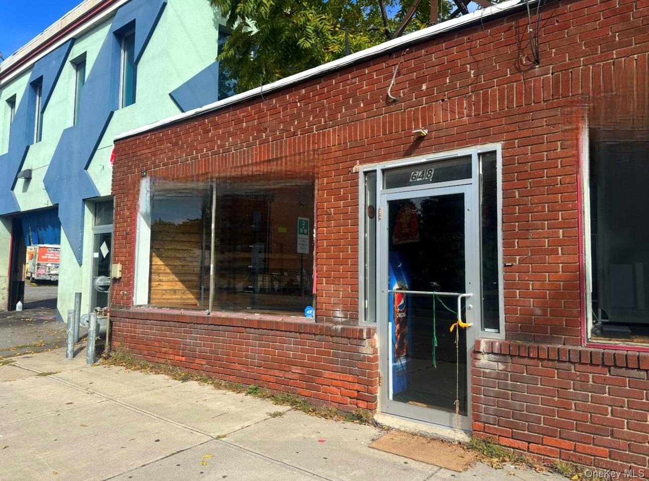 Doorway to property featuring brick siding