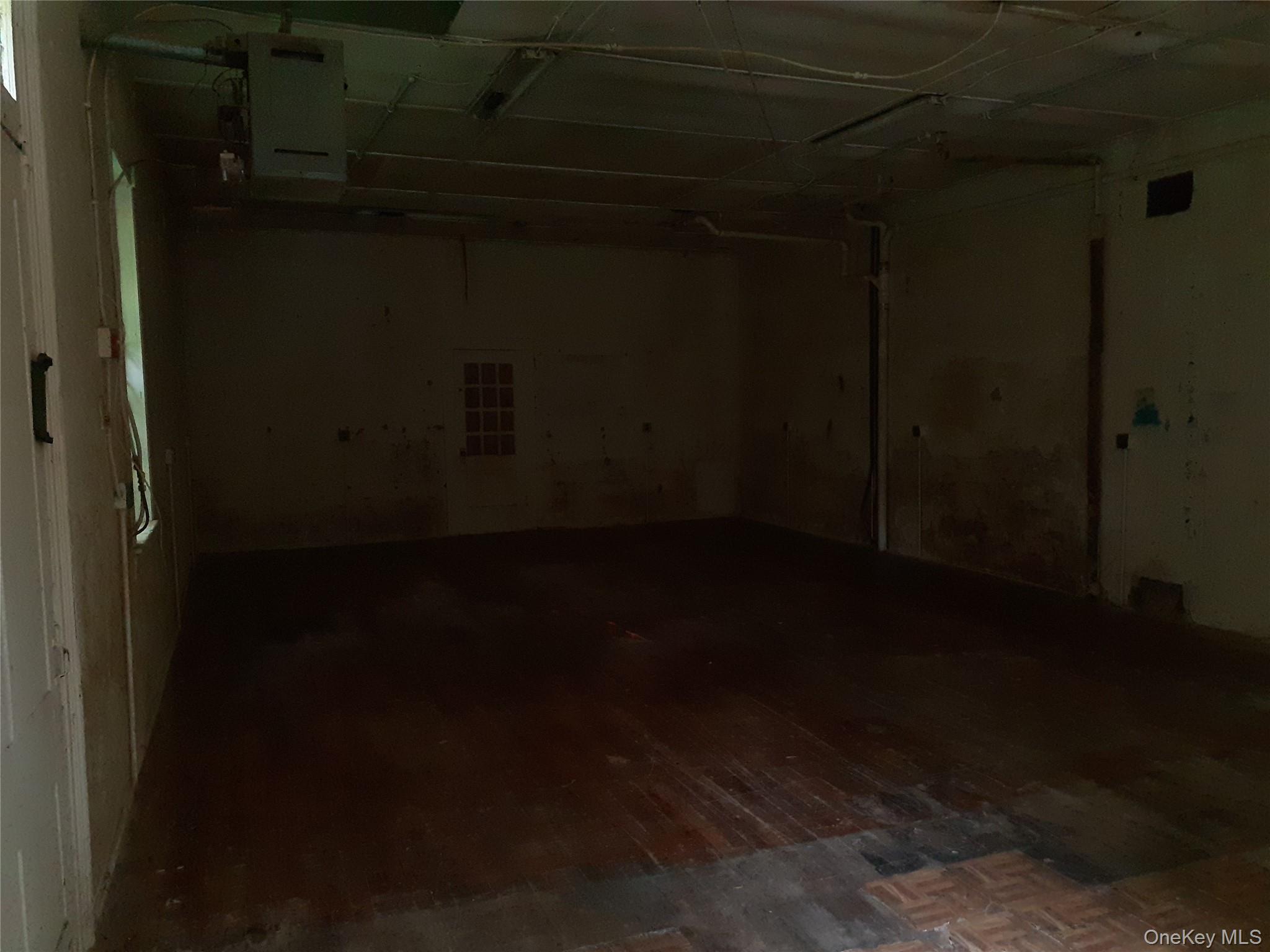 Below grade area with dark wood-type flooring and a garage