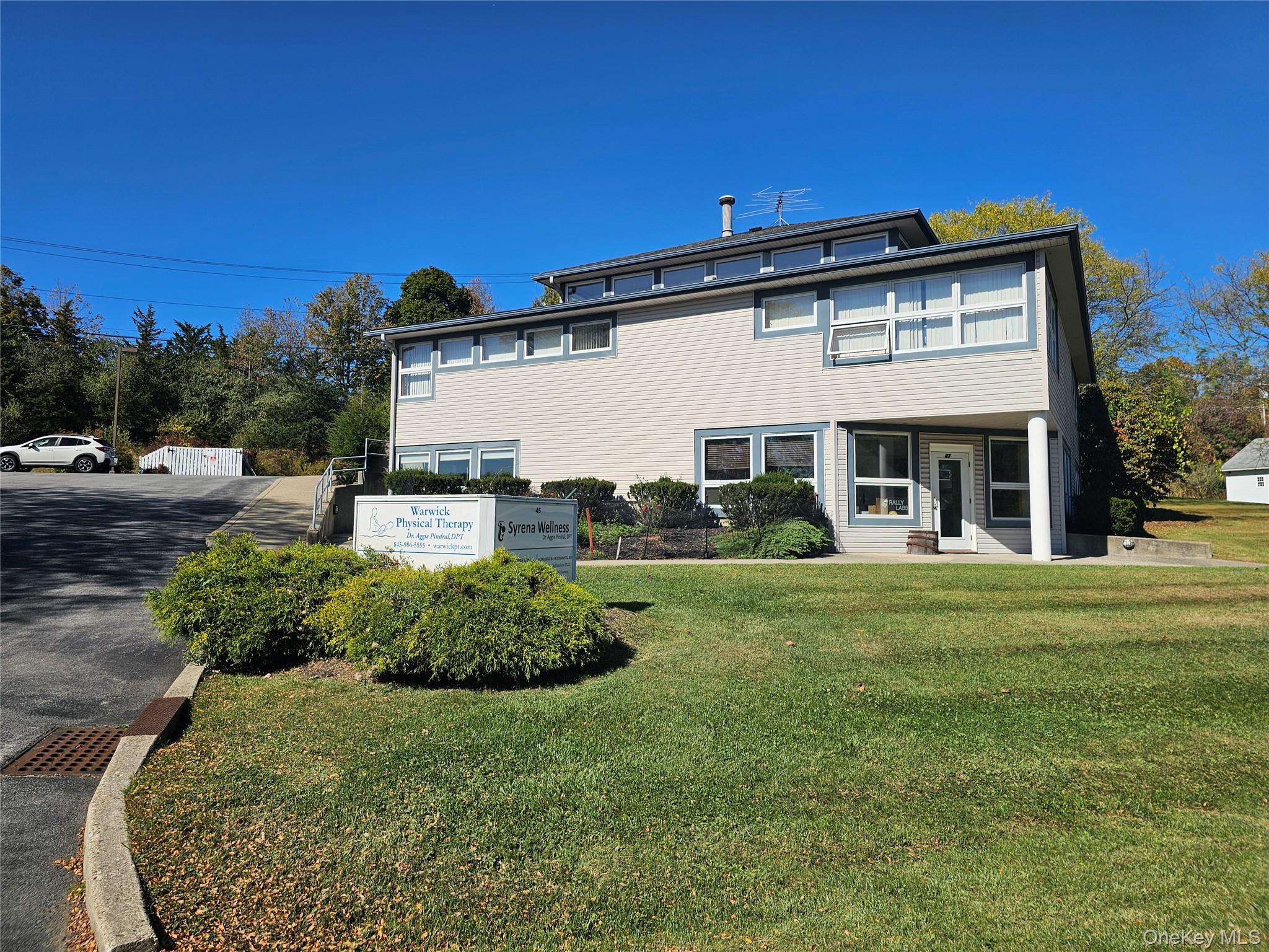 Rear view of property with a lawn
