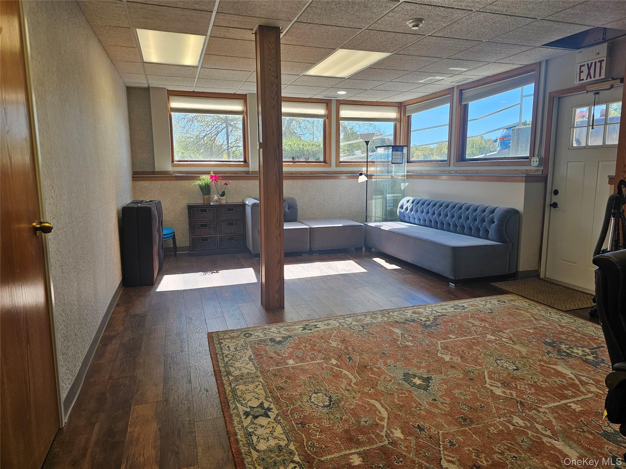 Foyer featuring dark wood finished floors and a drop ceiling