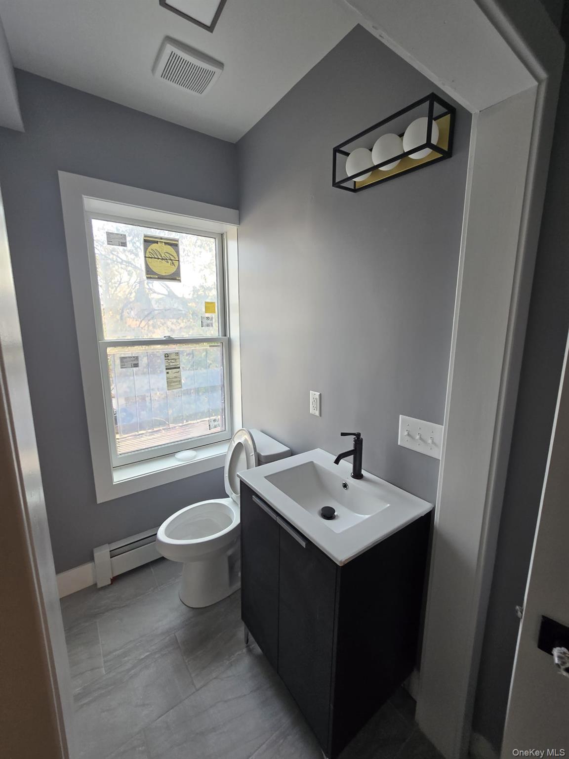 Bathroom featuring vanity and a baseboard radiator