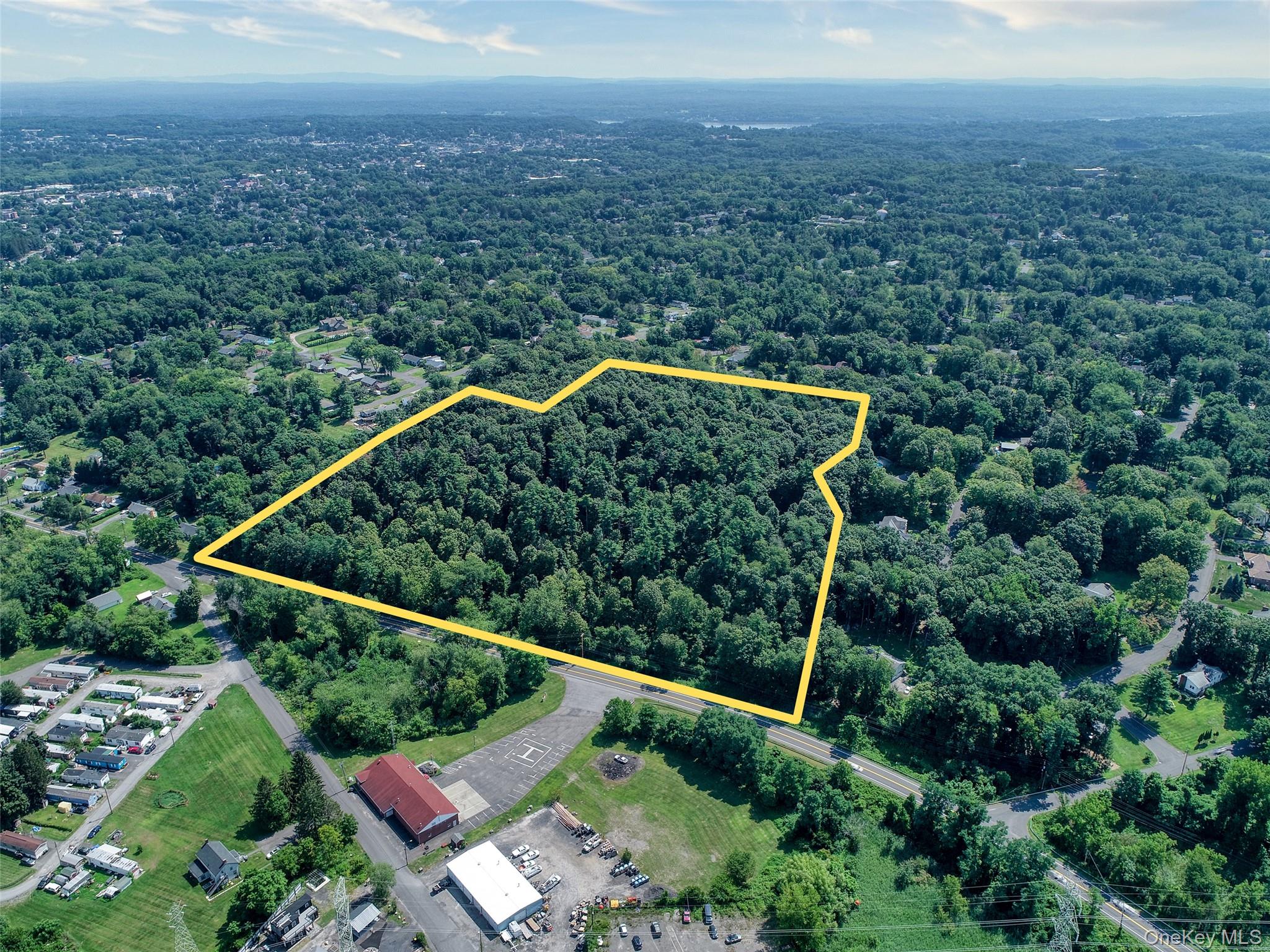 Aerial view of property and surrounding area with property boundaries highlighted