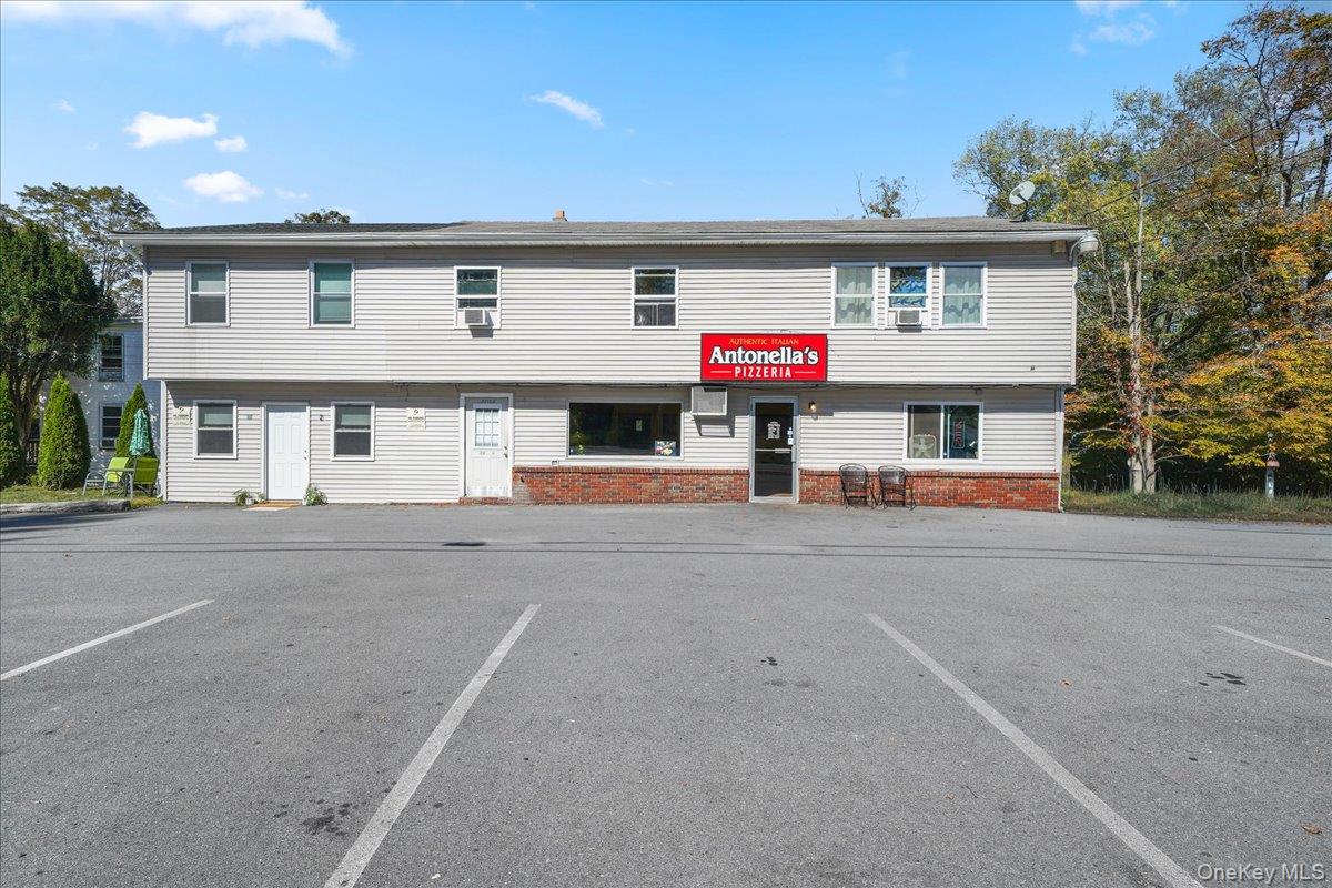 View of property with paved parking lot