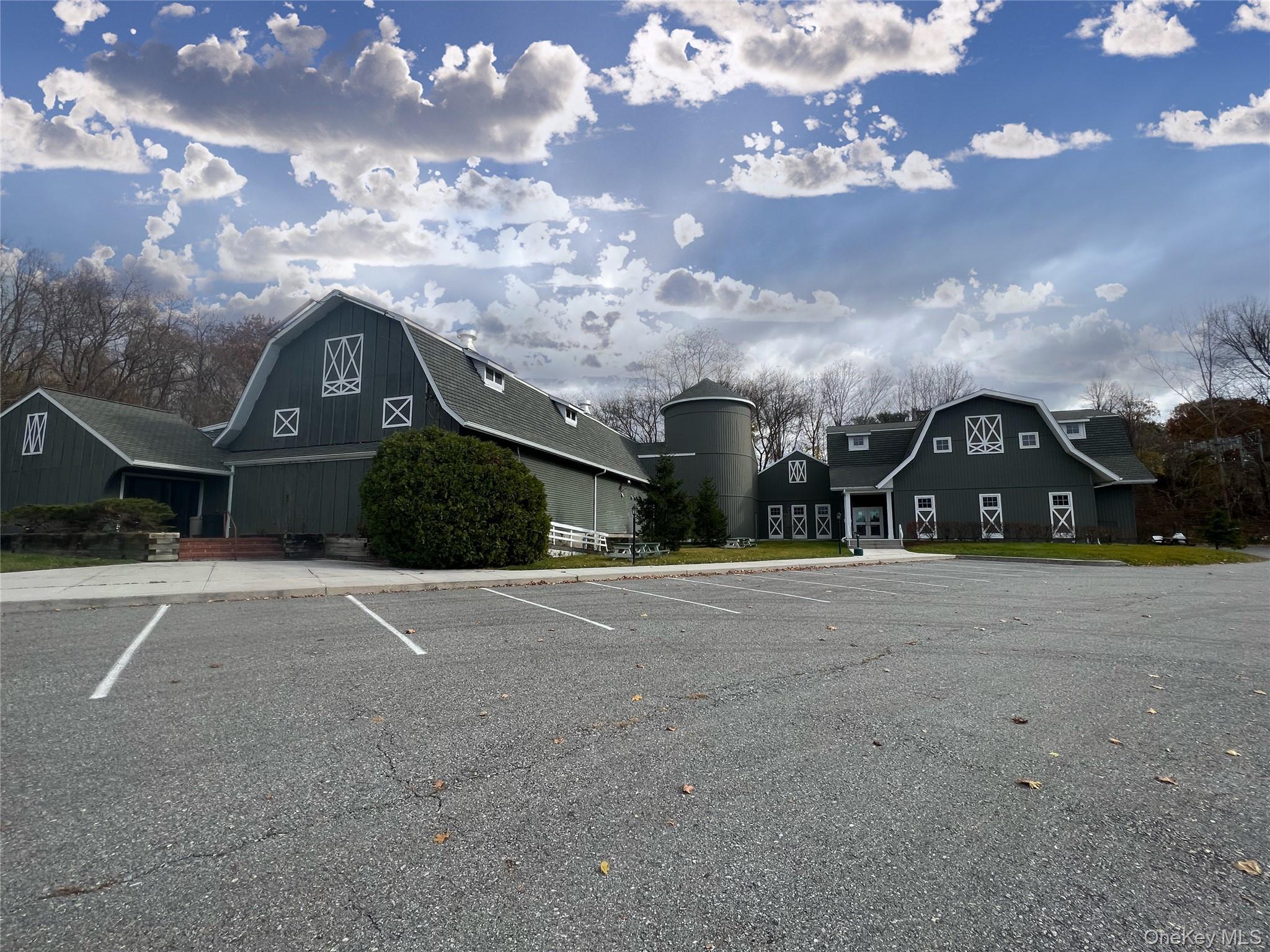 Uncovered parking lot with a barn
